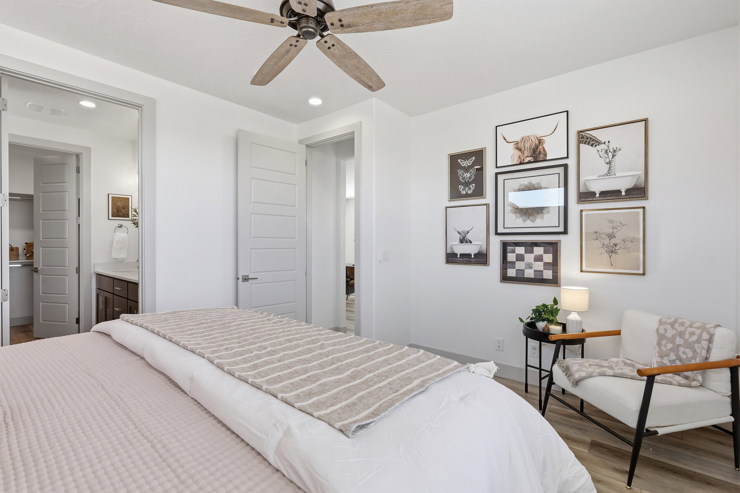Spacious room featuring light wood-finish flooring, a ceiling fan, and recessed lighting