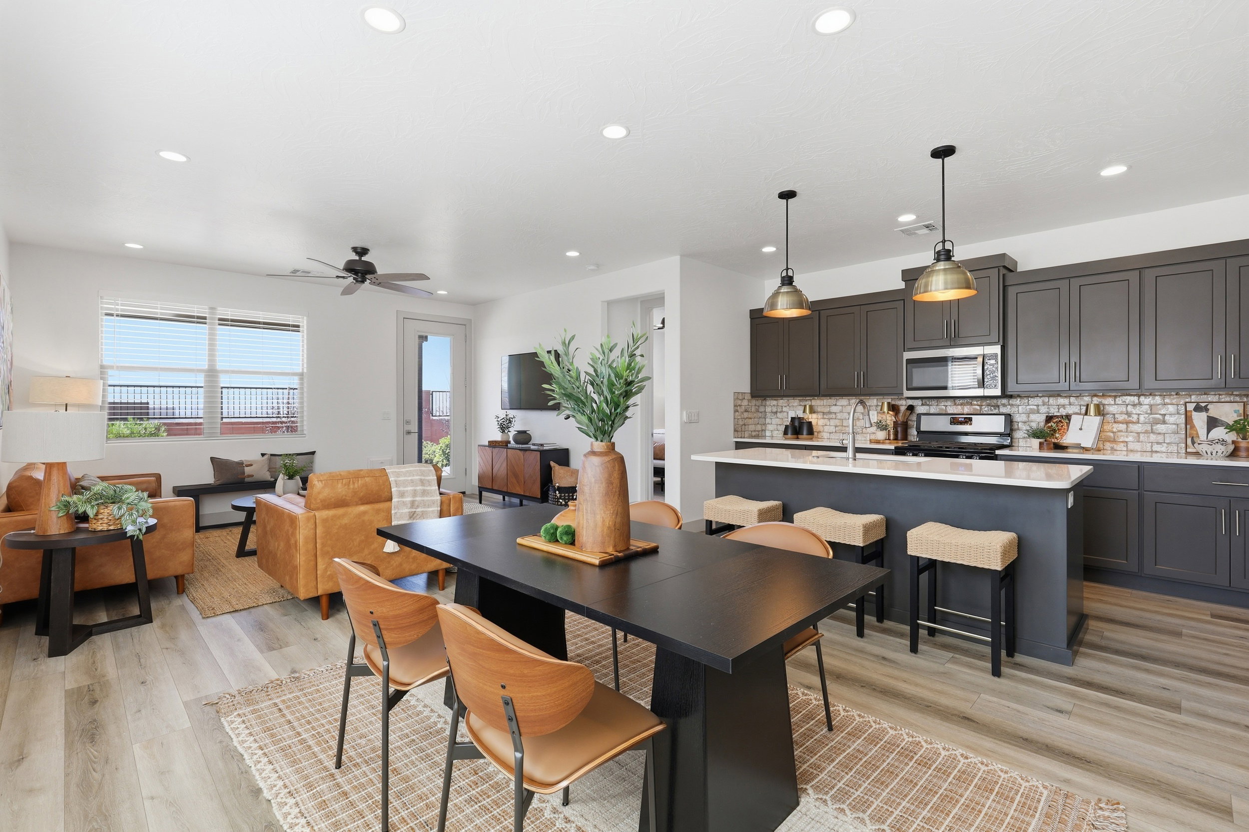 Open-concept living space featuring wood-finish flooring, recessed lighting, and a ceiling fan