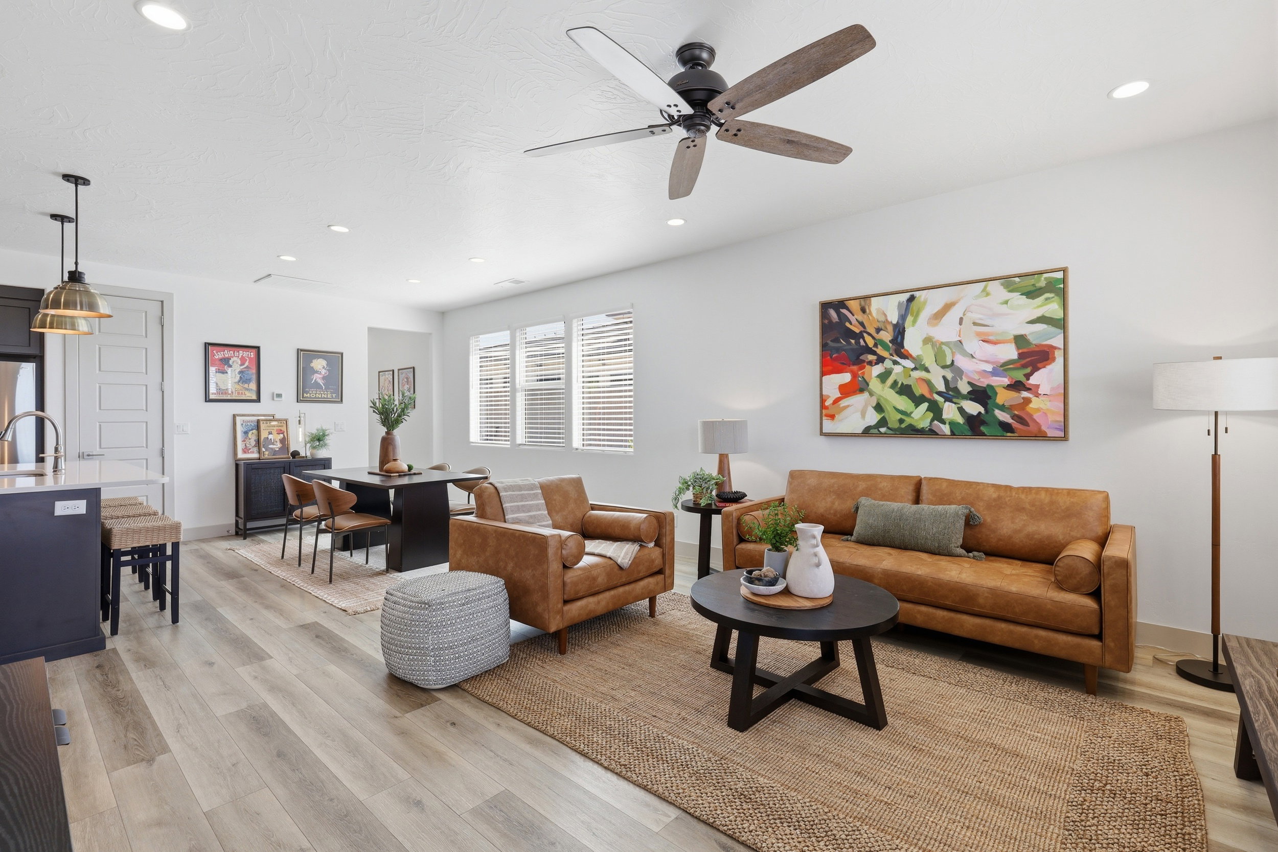 Open-concept living space featuring wood-finish flooring, recessed lighting, and a ceiling fan