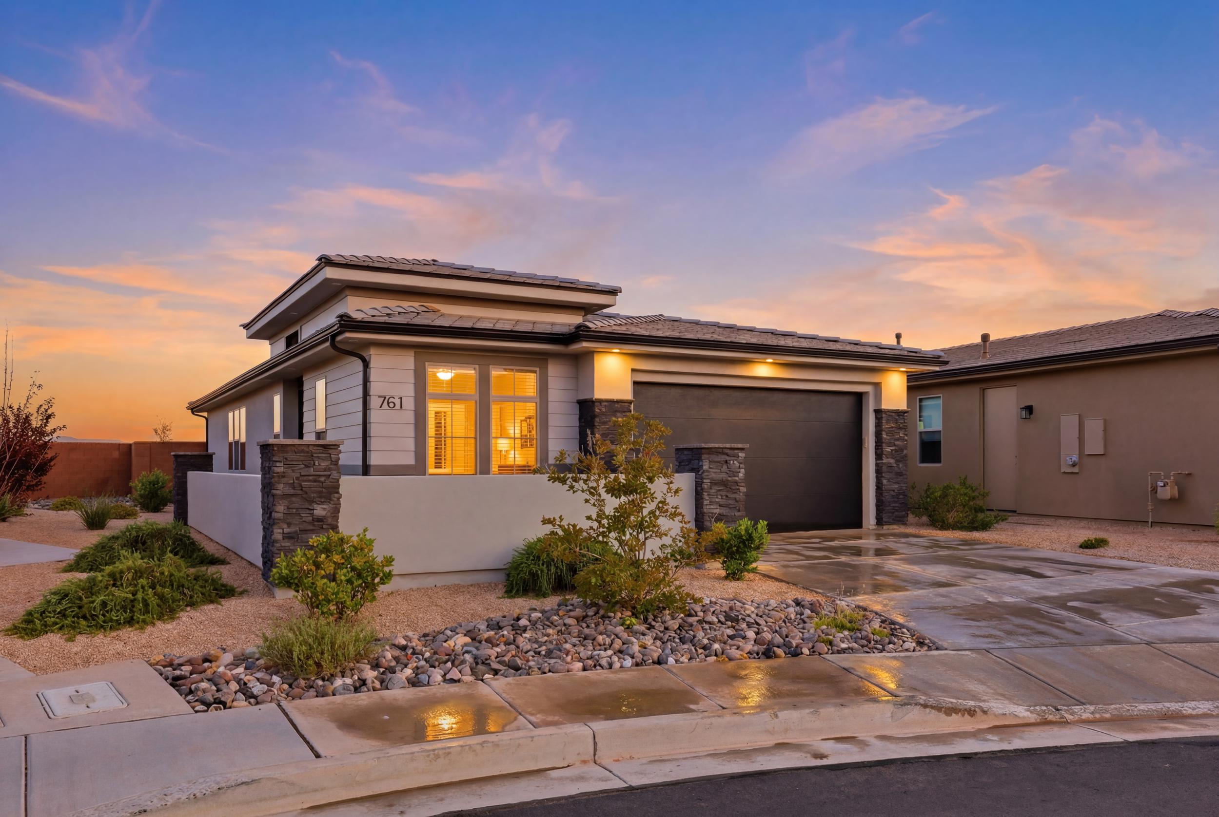 Contemporary stucco and siding exterior with stone accents