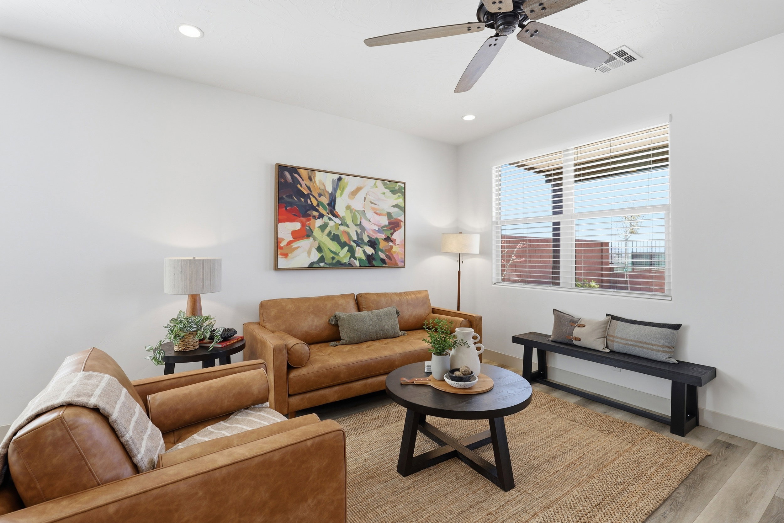 Bright interior space featuring light-toned walls, recessed lighting, and a ceiling fan