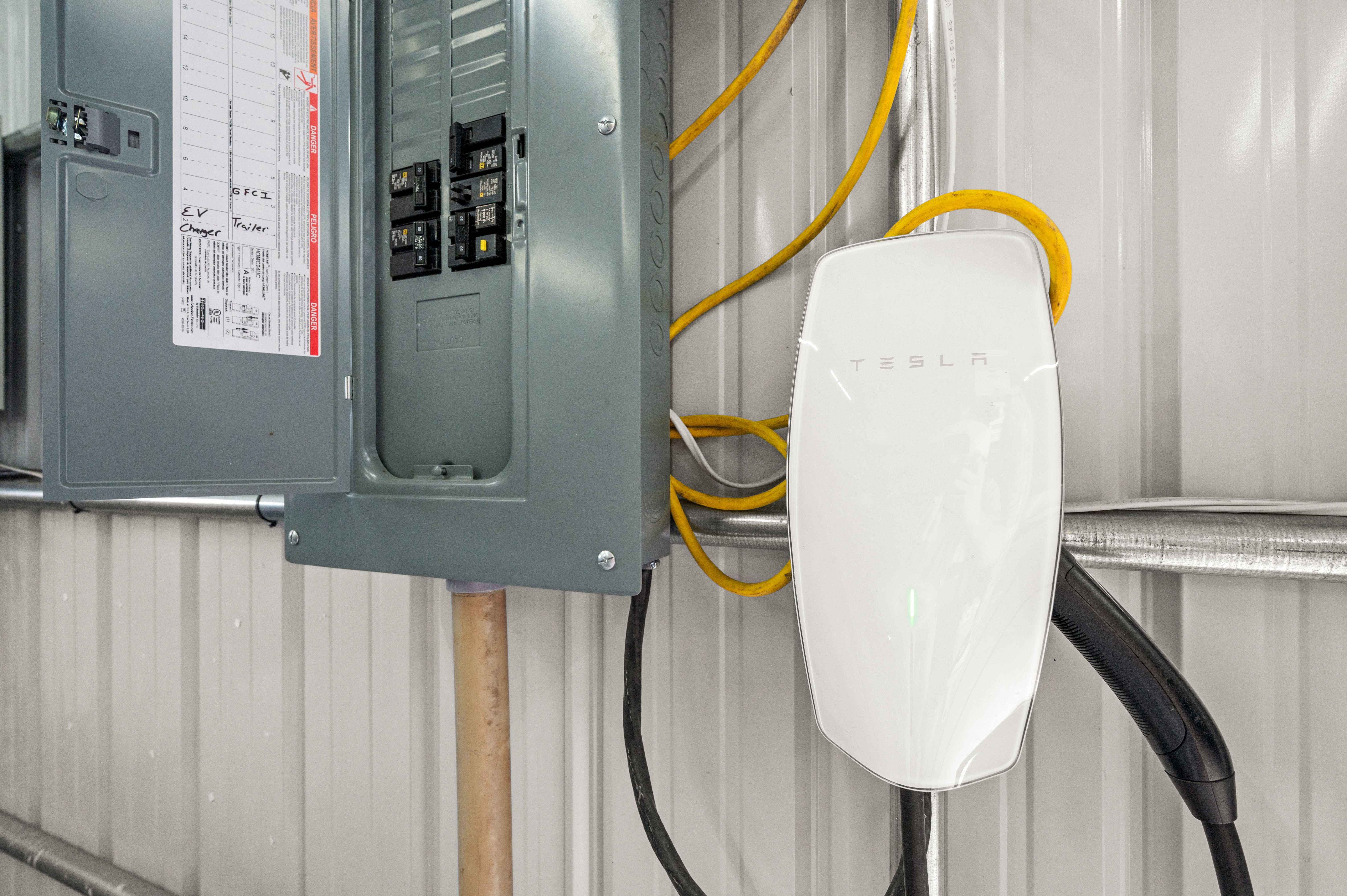 Tesla electric vehicle charging station with corresponding circuit breaker panel