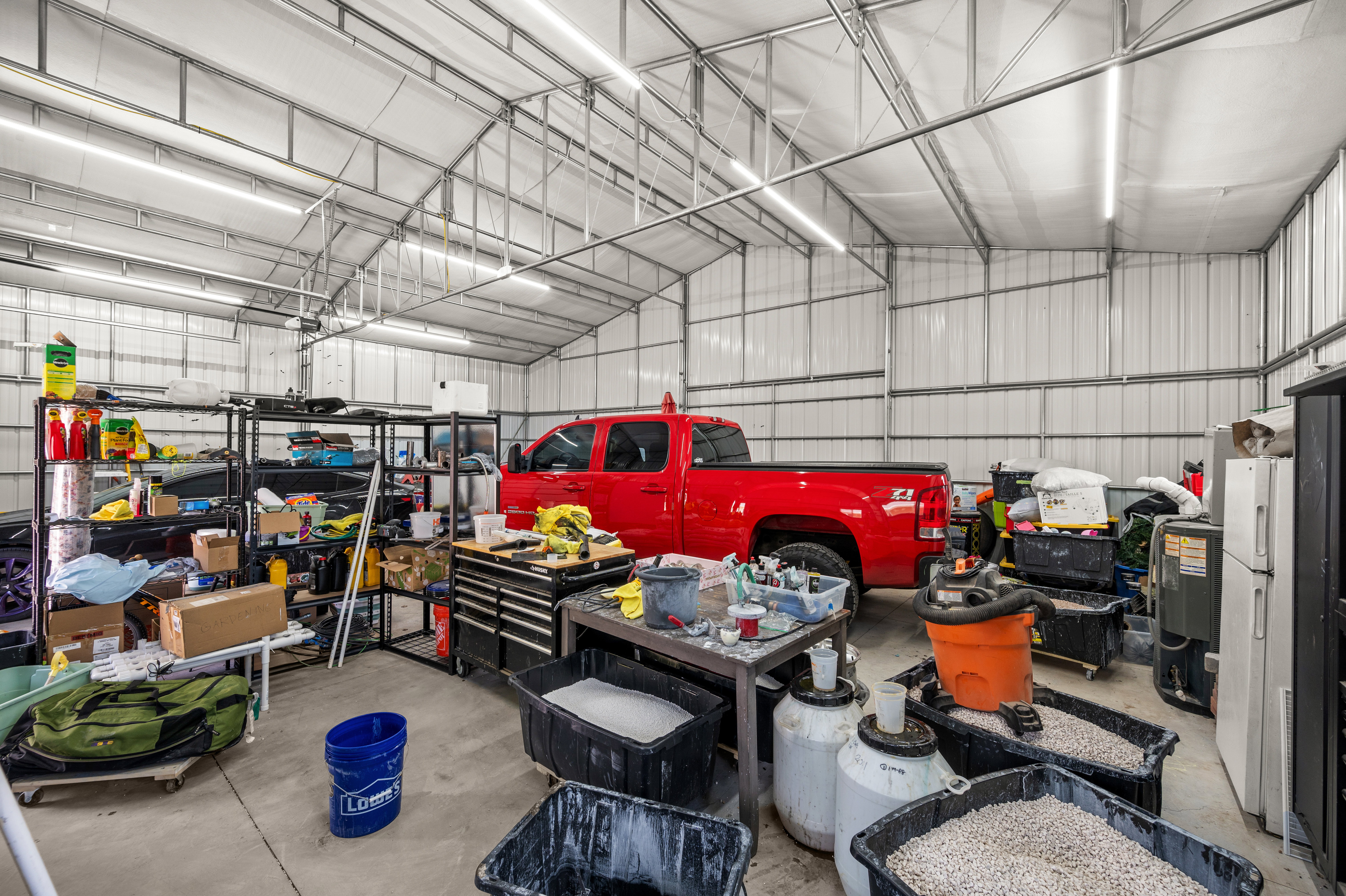 Spacious metal building featuring a vaulted ceiling and concrete flooring