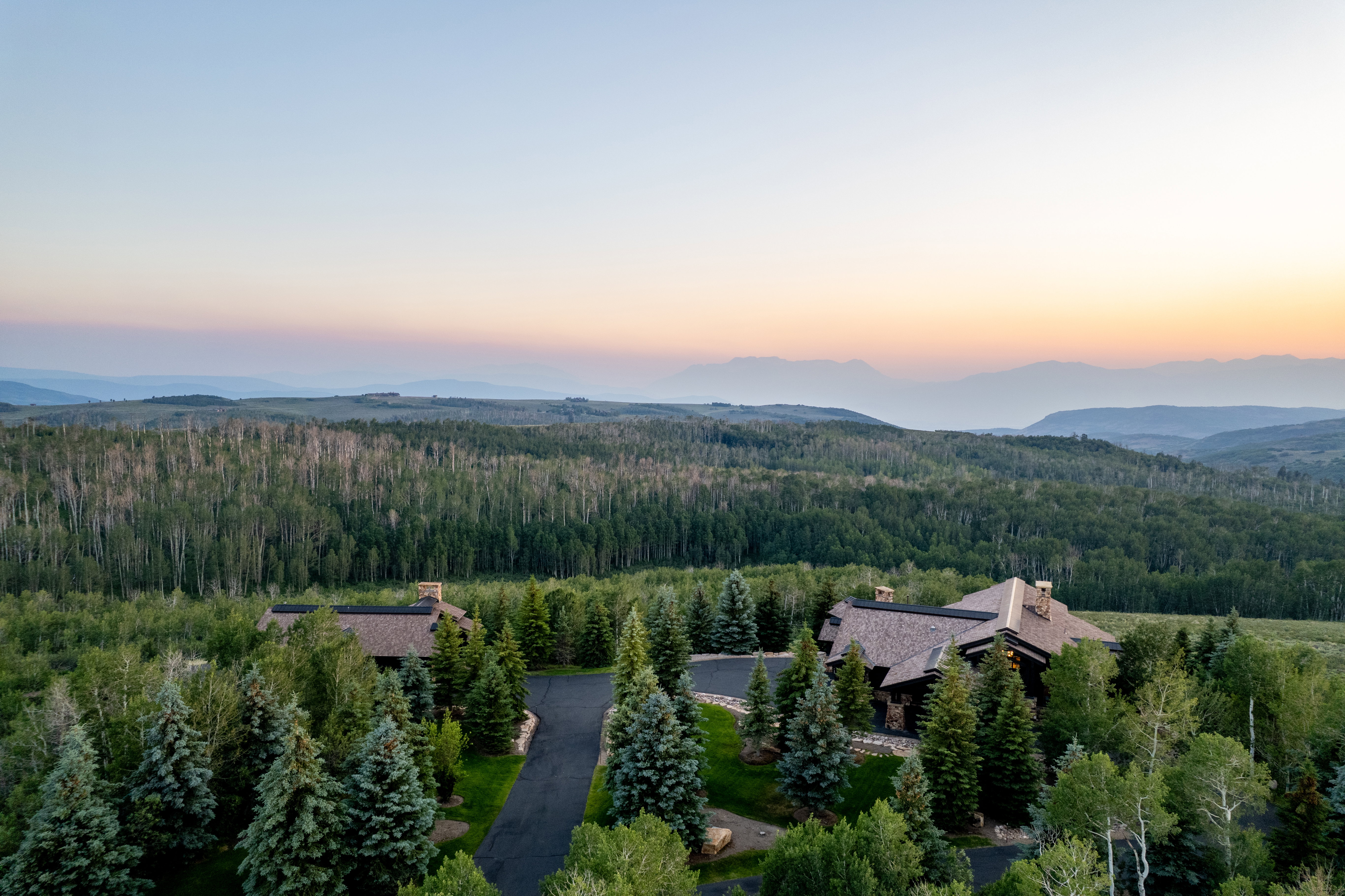 Sprawling property featuring two distinct structures with natural wood siding and shingle roofs