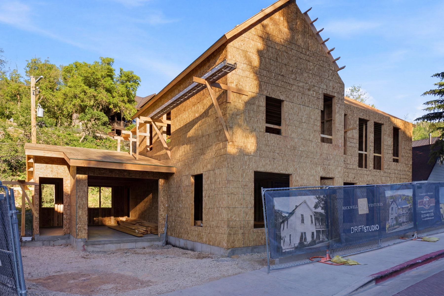New construction framing featuring a multi-level design and an attached covered portico