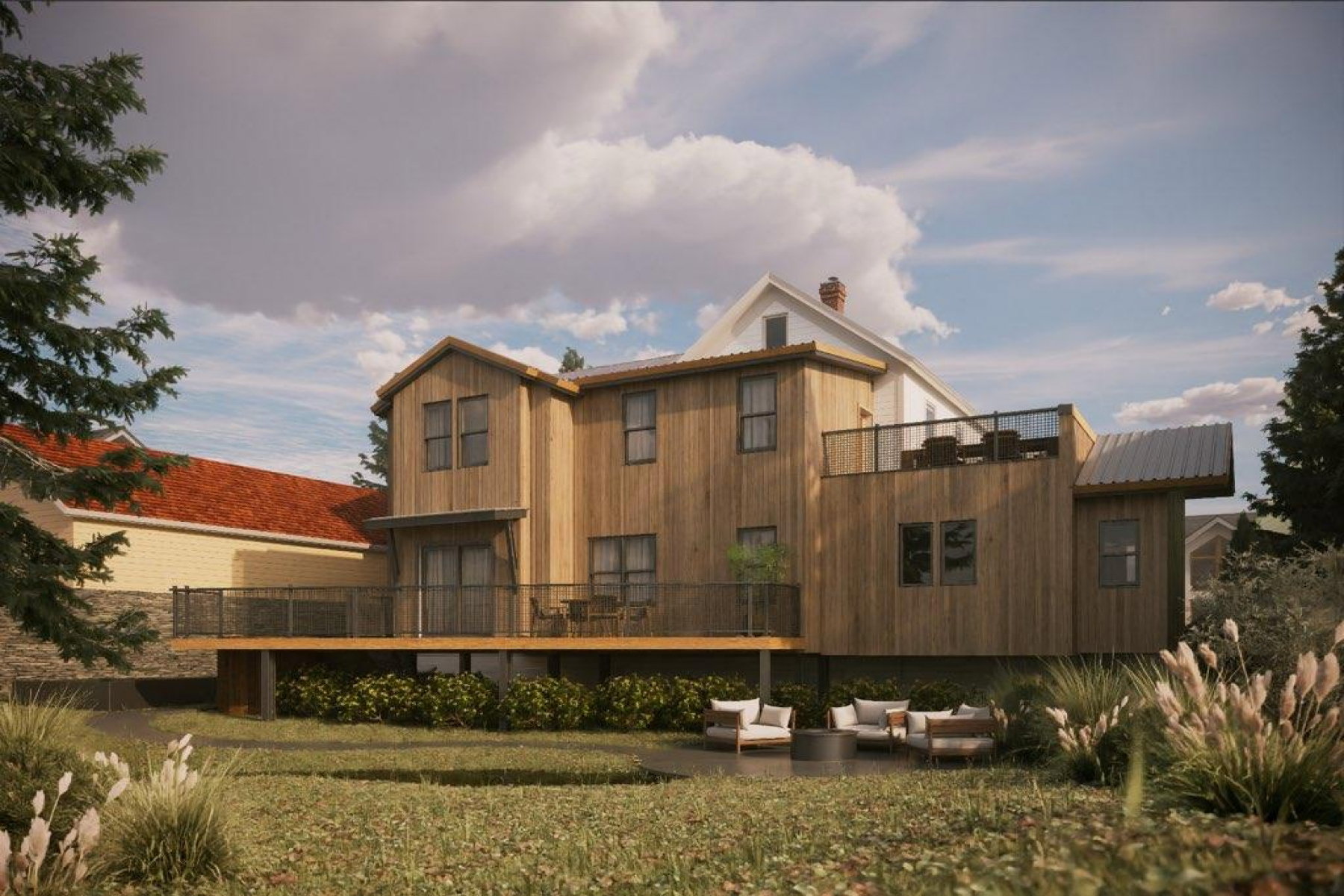 Contemporary rear elevation with natural wood siding, multiple outdoor deck spaces, and a ground-level patio