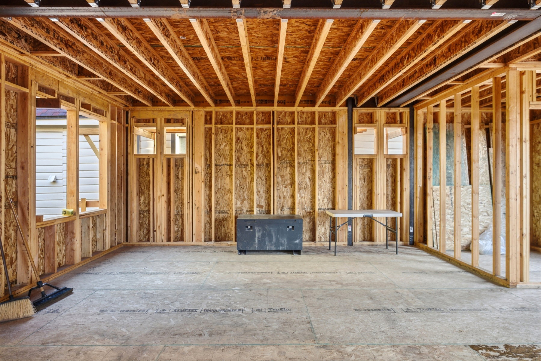 Interior framing showcasing exposed wood studs and ceiling joists