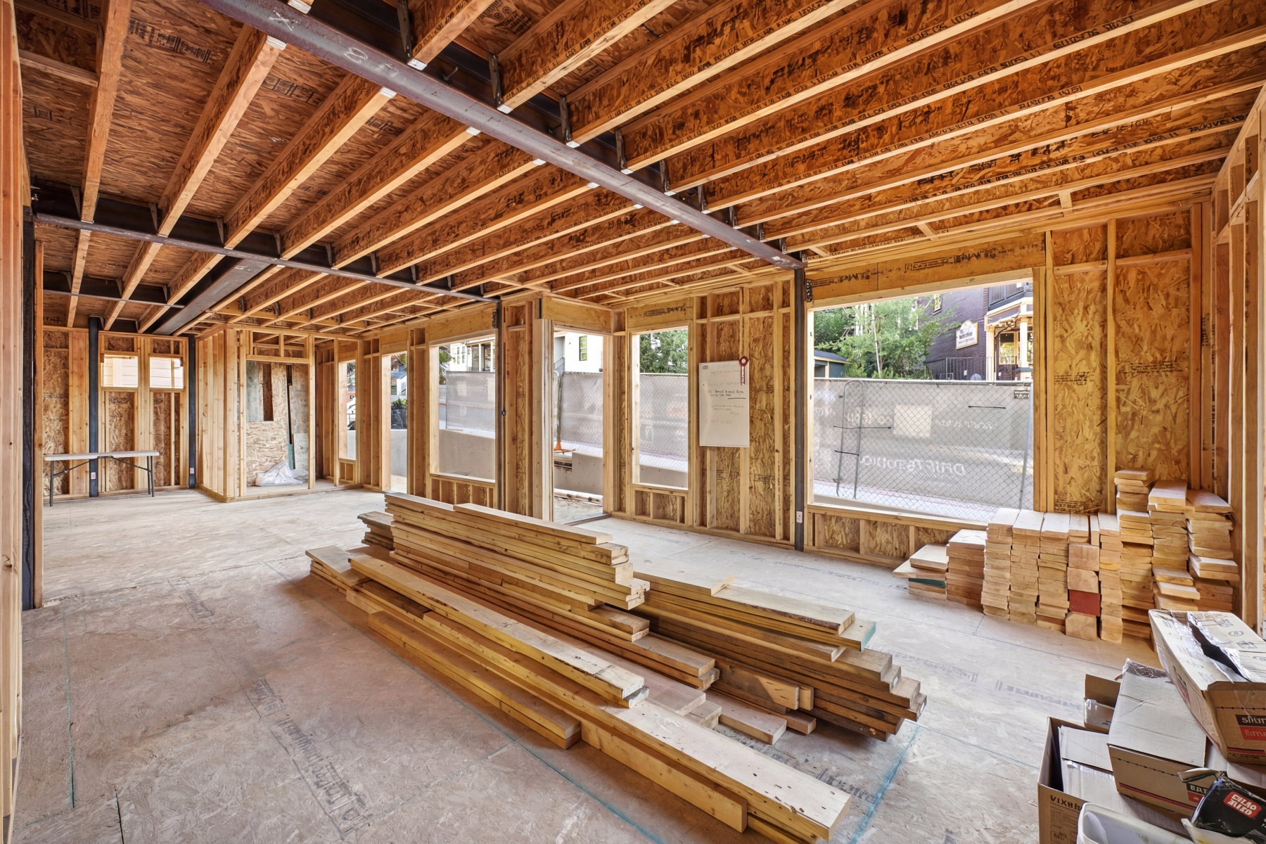 Open-concept framing with exposed wood joists and structural steel beams