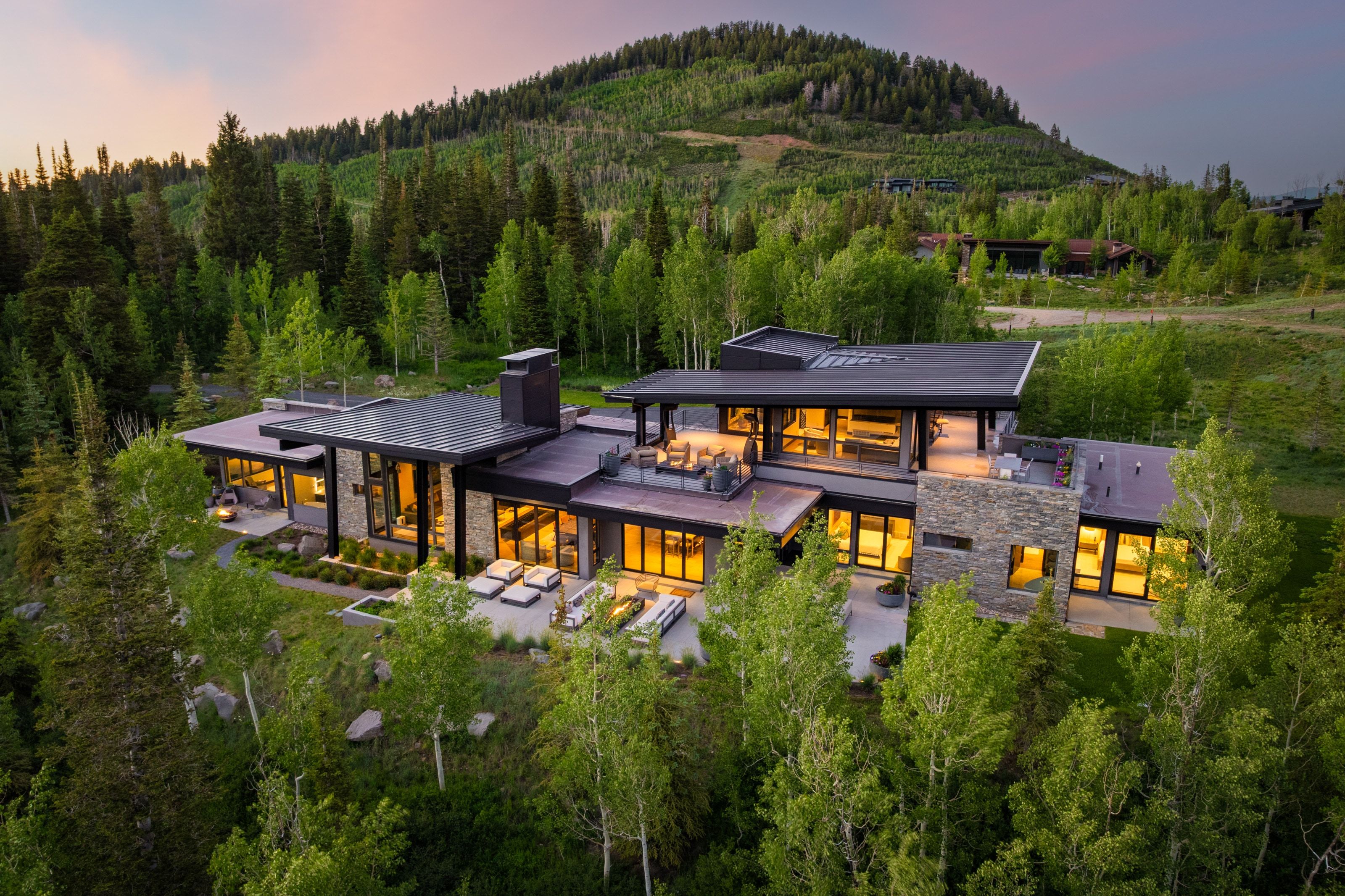 Modern mountain residence featuring a multi-level design with extensive outdoor patio spaces