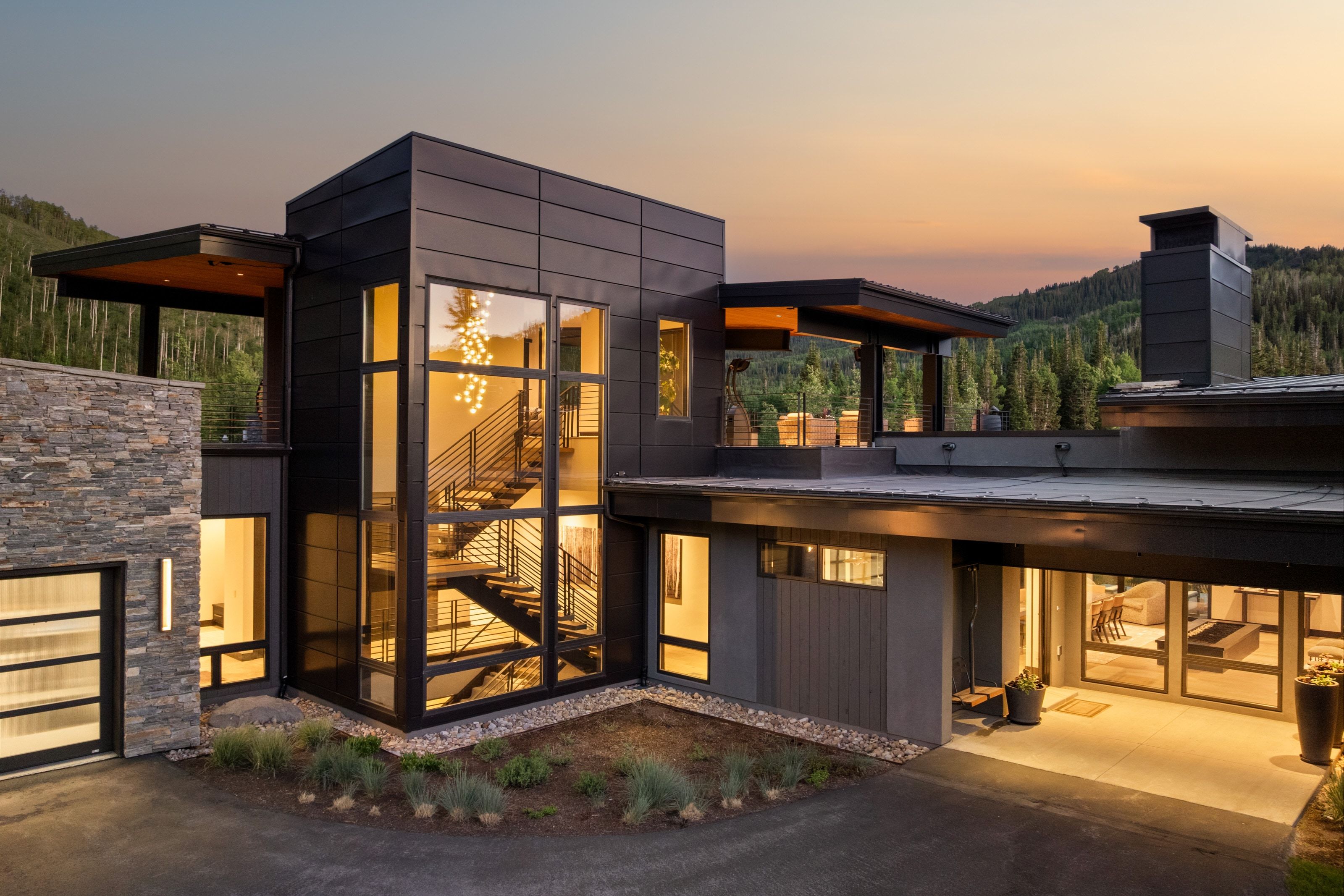 Modern architectural exterior featuring mixed materials including stone facade and dark paneling