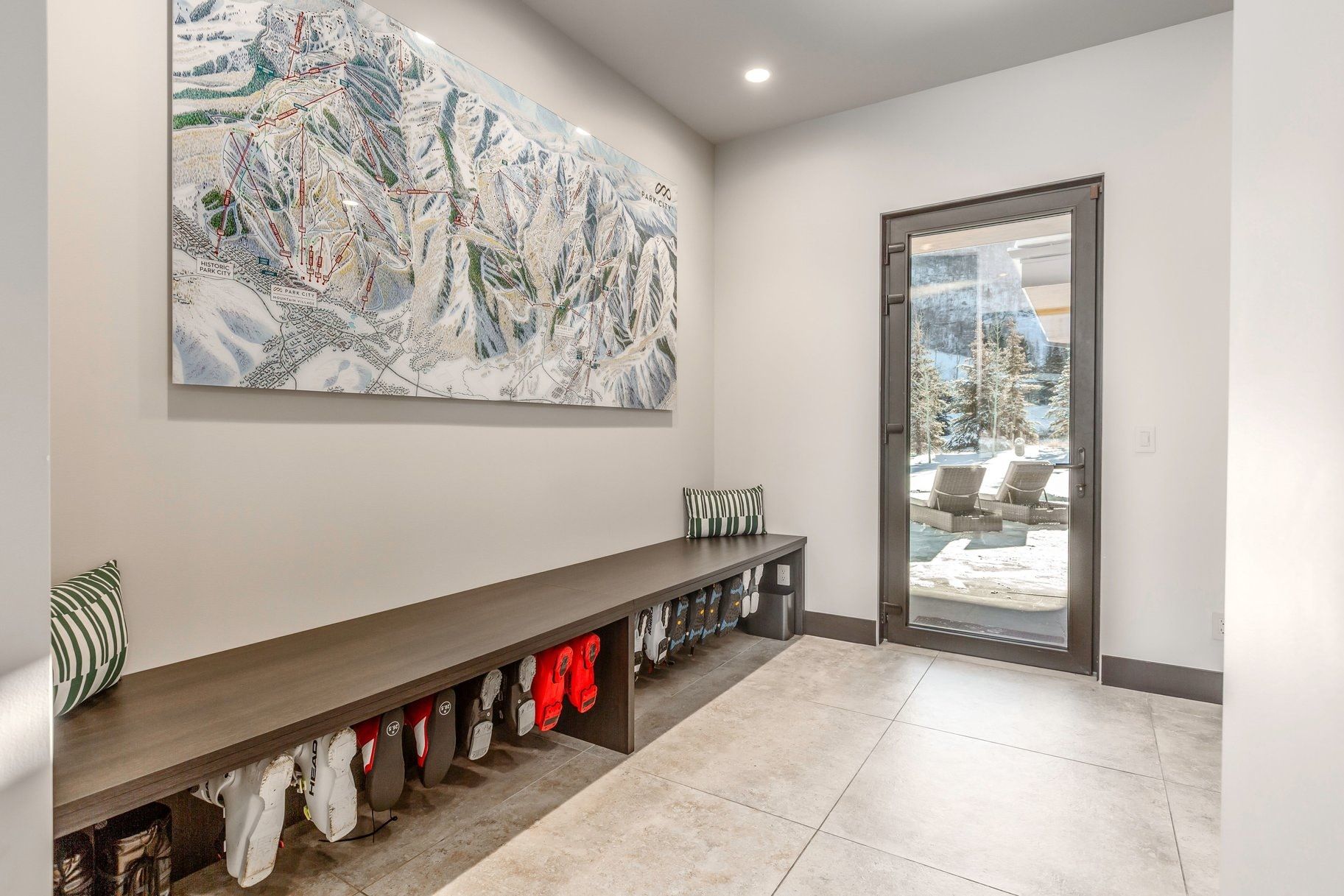 Entryway featuring a built-in bench with integrated storage, large format tile flooring, and a full-light exterior door