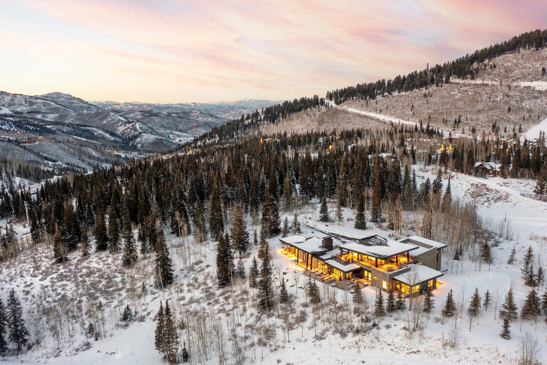 Contemporary mountain residence with multiple expansive outdoor living areas and a flat roofline