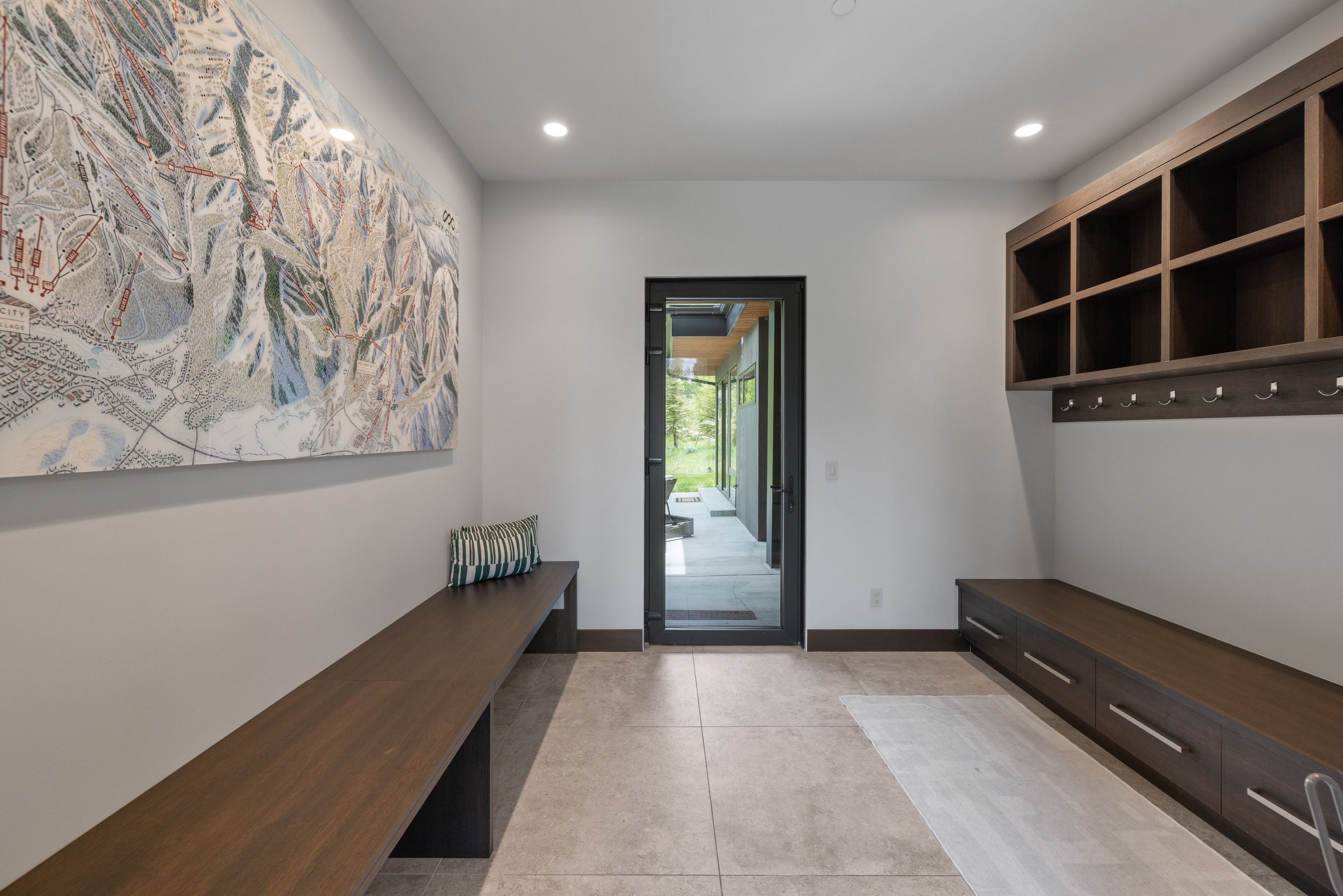 Mudroom featuring durable tile flooring, recessed lighting, and a modern glass-paneled exterior door