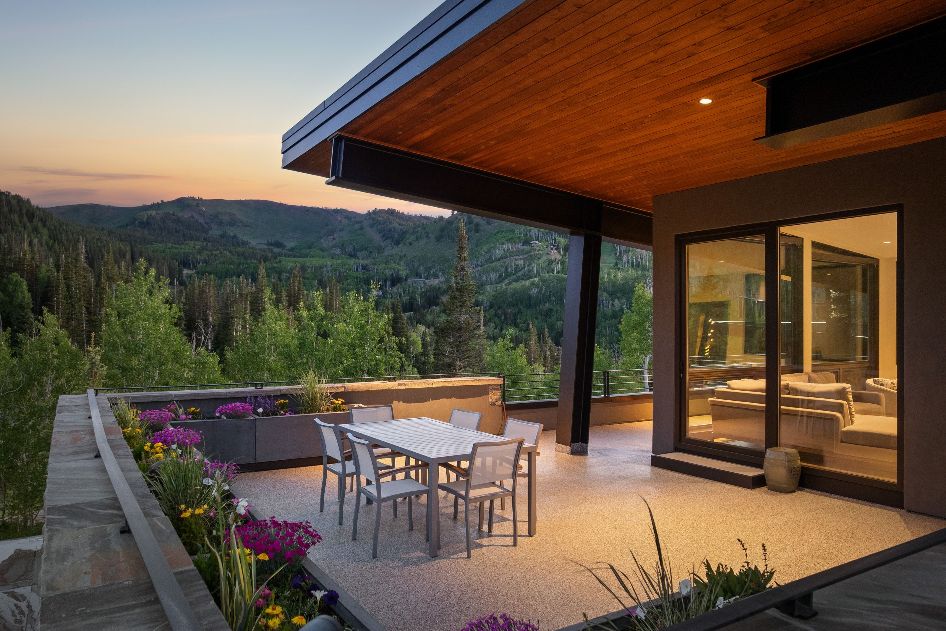 Expansive outdoor patio featuring a wood-finish ceiling, recessed lighting, and a sliding glass door