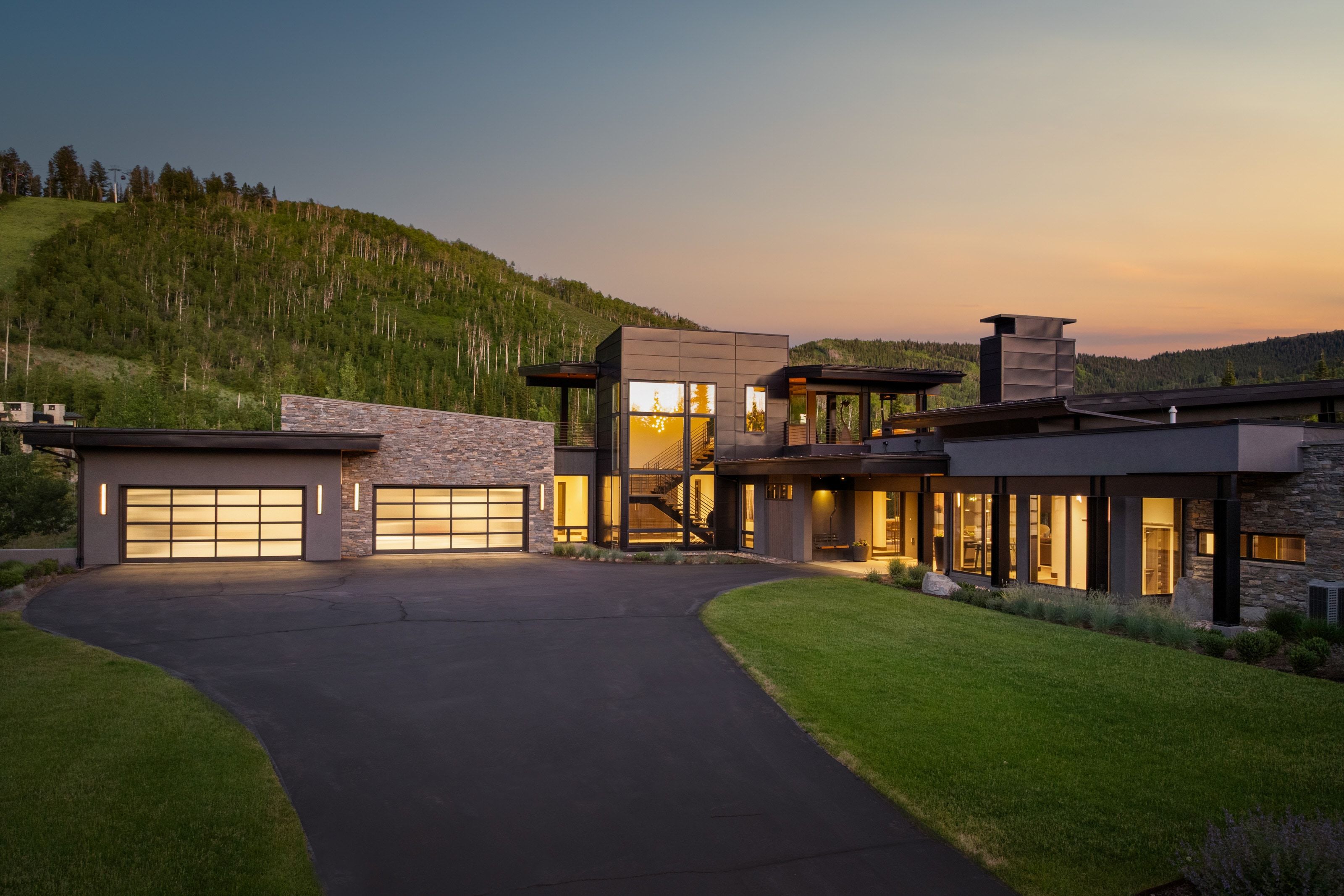 Modern architectural residence featuring multiple levels and a stone and stucco facade