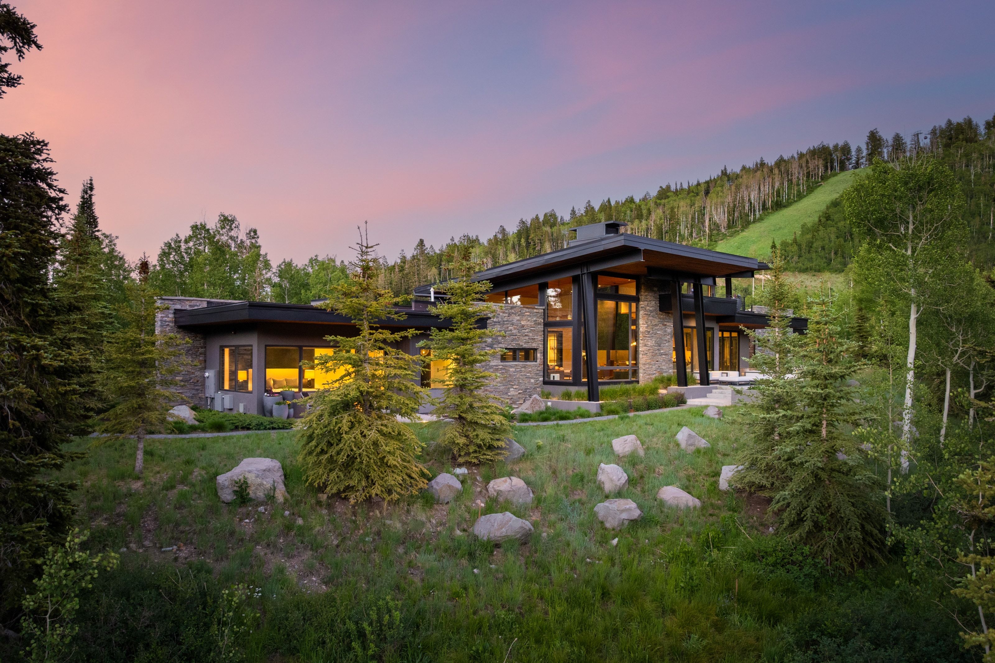 Contemporary mountain residence featuring a multi-level design and a stone and wood exterior