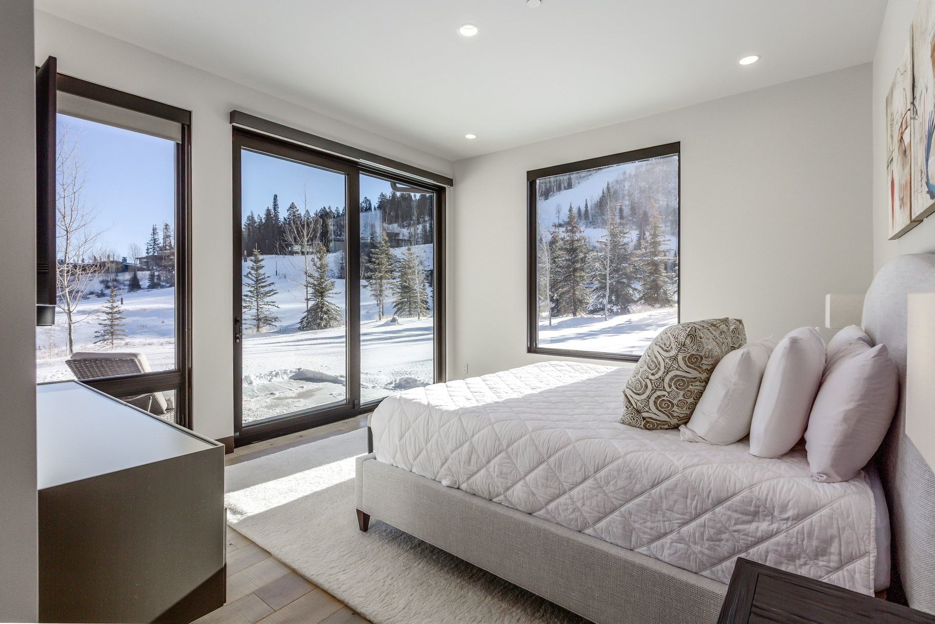 Bedroom featuring large windows, wood-finish flooring, recessed lighting, and a sliding glass door