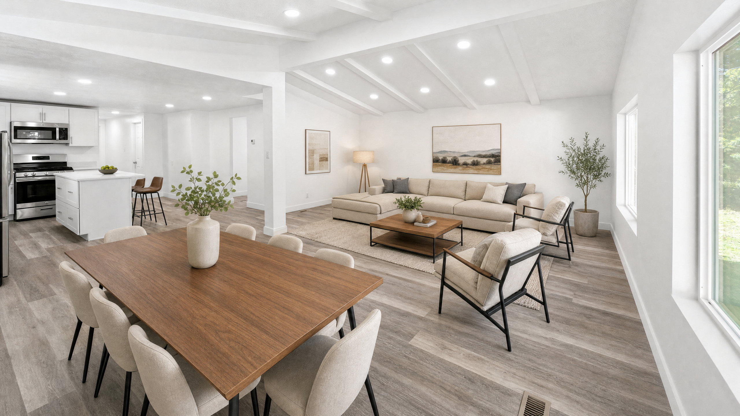 Bright interior featuring wood-finish flooring, recessed lighting, and a kitchen with stainless steel appliances