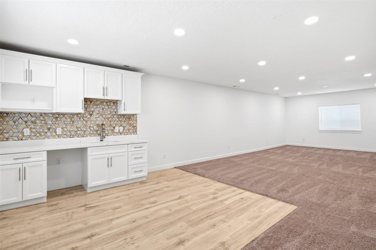 Kitchenette in basement with area for Mini Fridge and Microwave. Touches Faucett