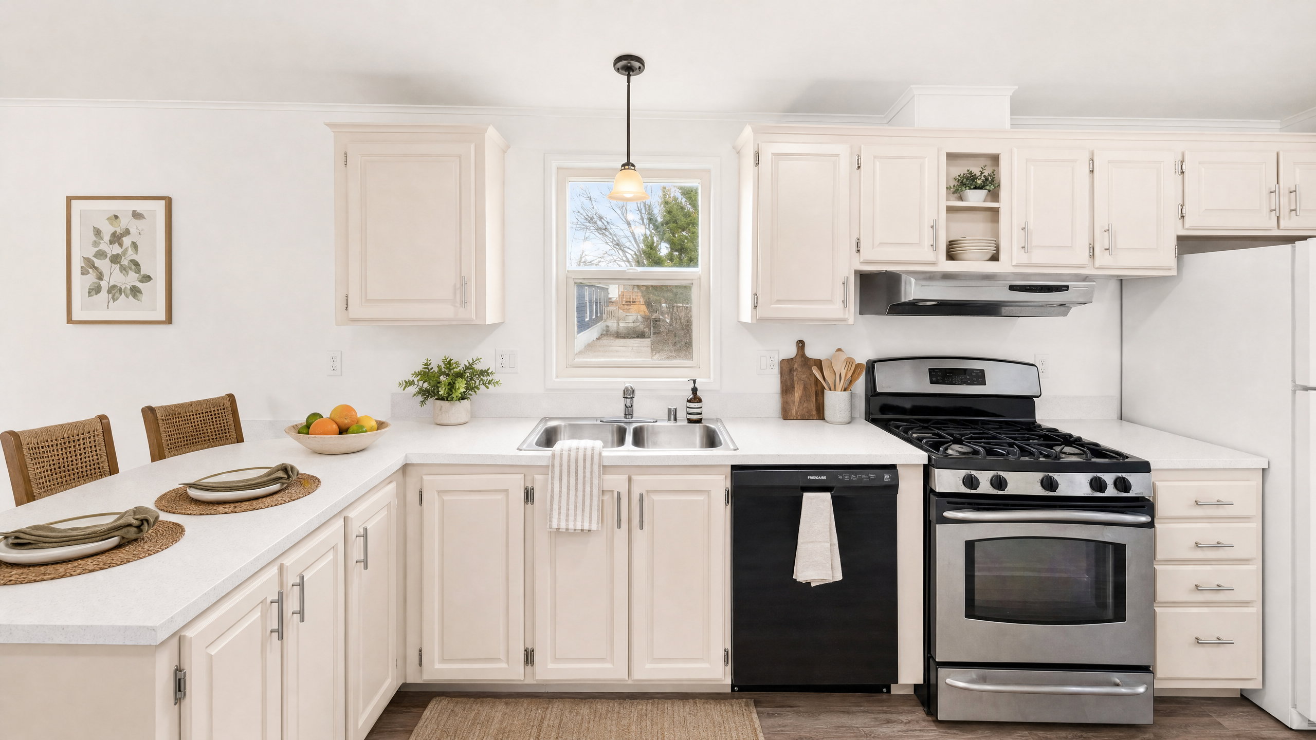 Kitchen featuring light-toned cabinetry, a stainless steel gas range, a black built-in dishwasher, and wood-finish flooring