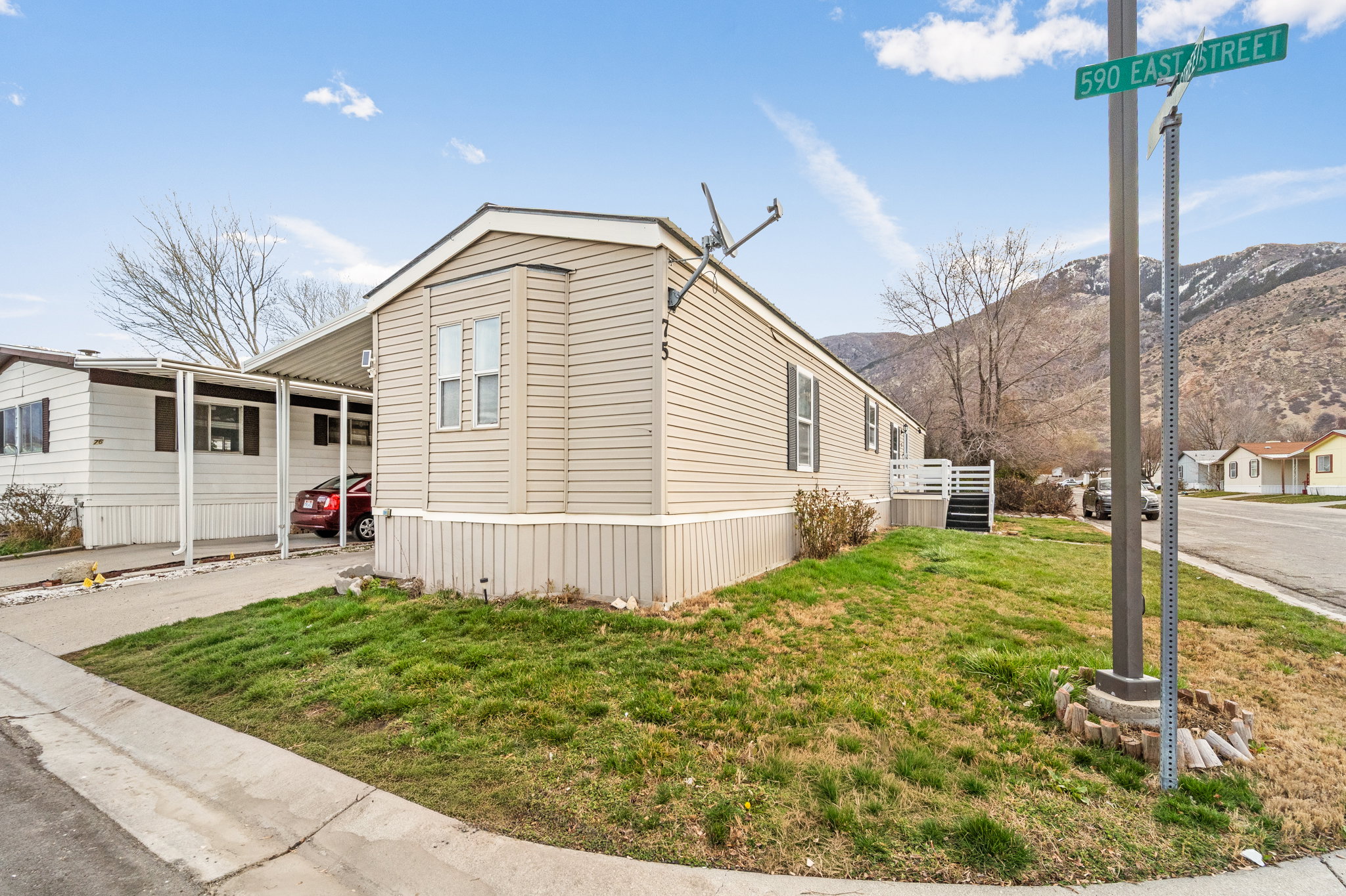 Manufactured home with beige siding and white trim