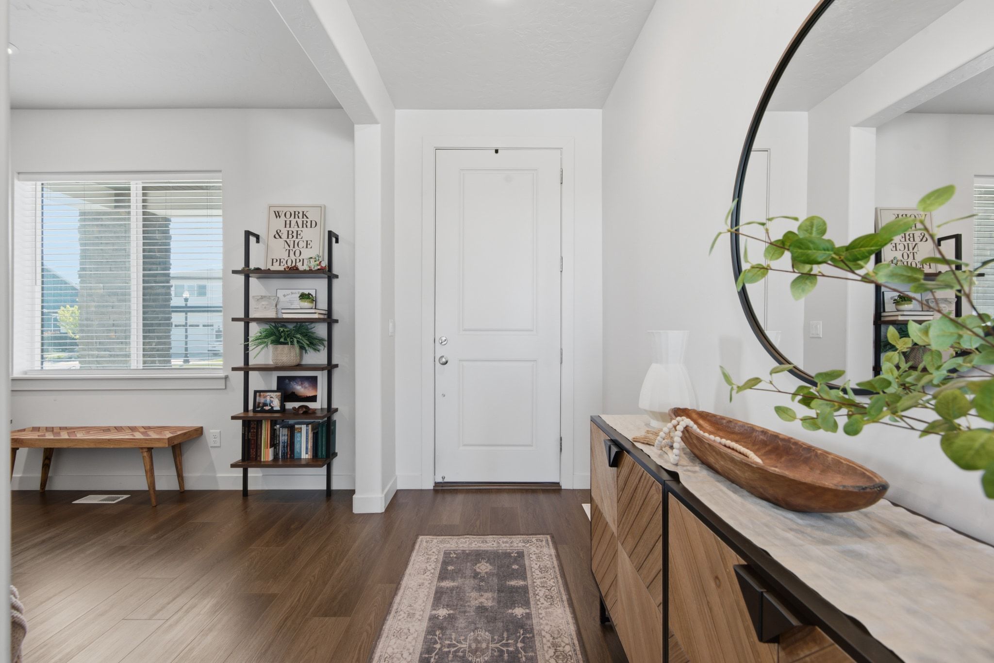Entryway featuring wood-finish flooring, white walls, and a white paneled door