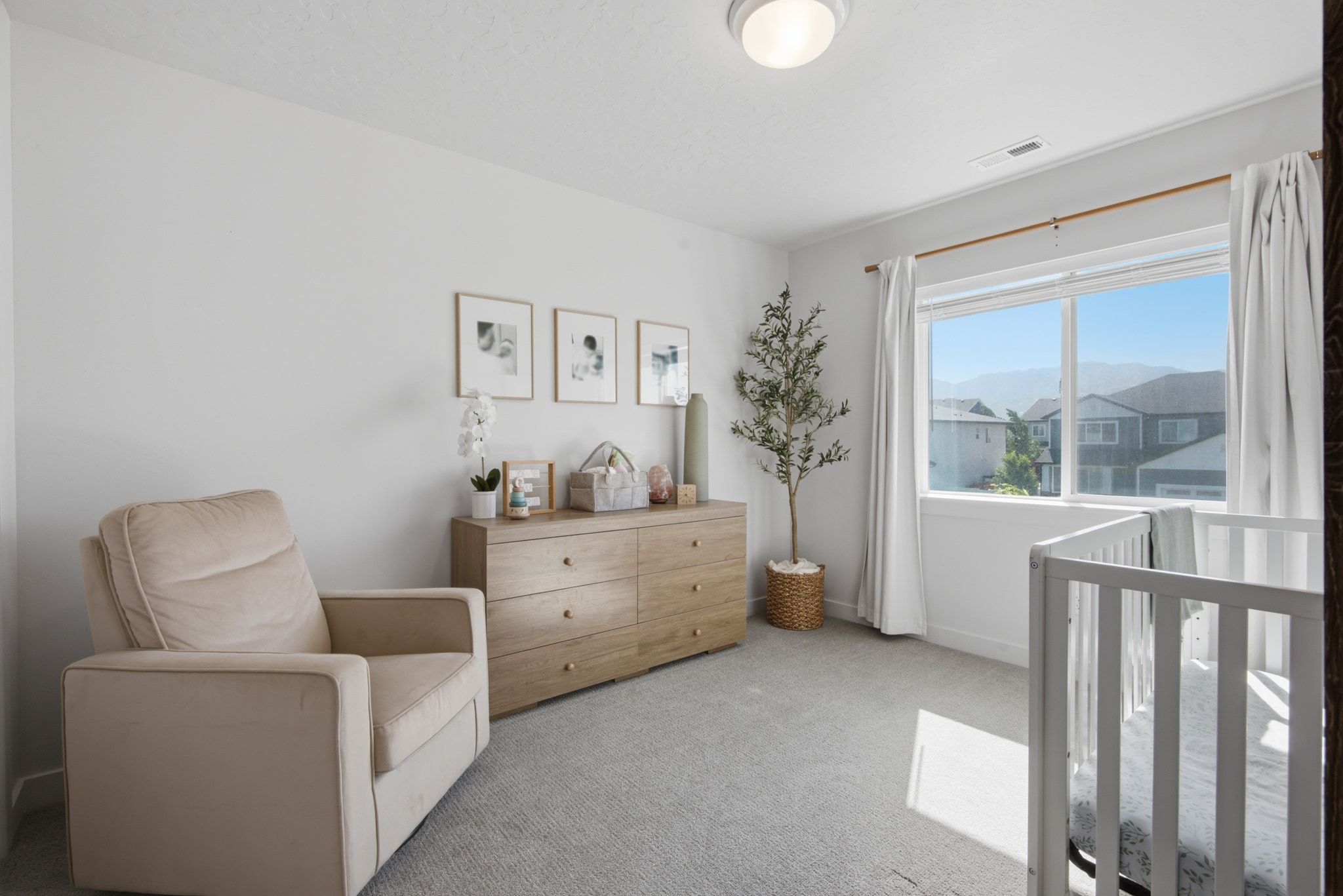 Bright room with neutral wall paint and light gray carpet