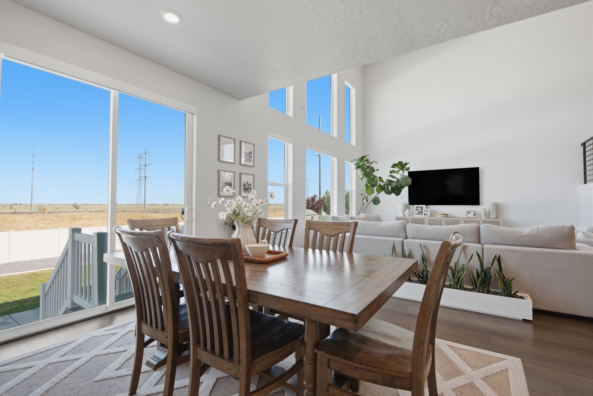 Dining area with wood-finish flooring and a rectangular dining table