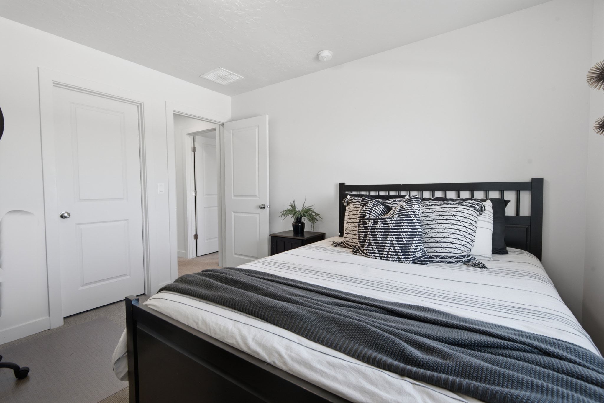 Interior room featuring light-colored walls and dark wood-finish flooring