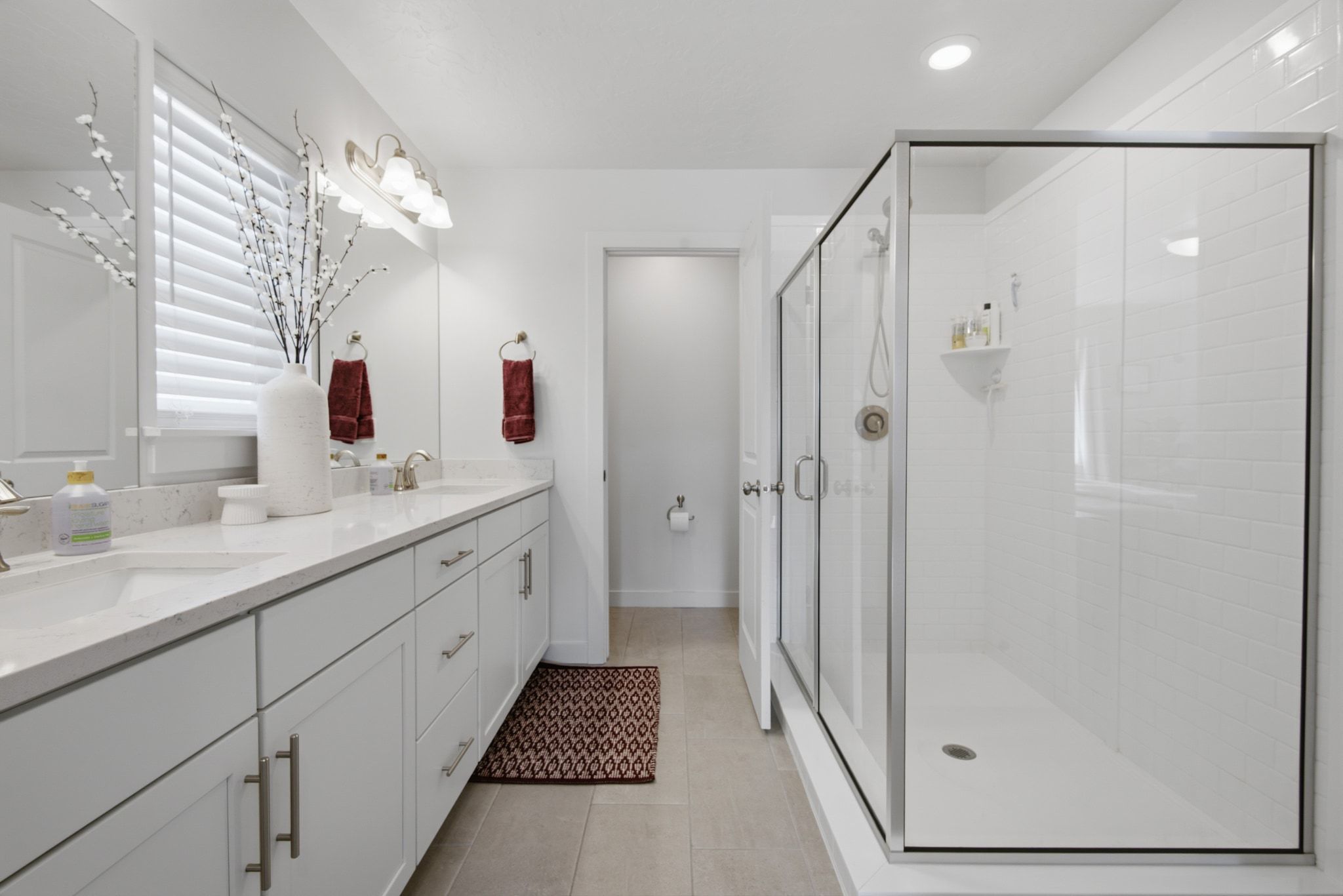 Dual vanity with undermount sinks and light-toned countertops