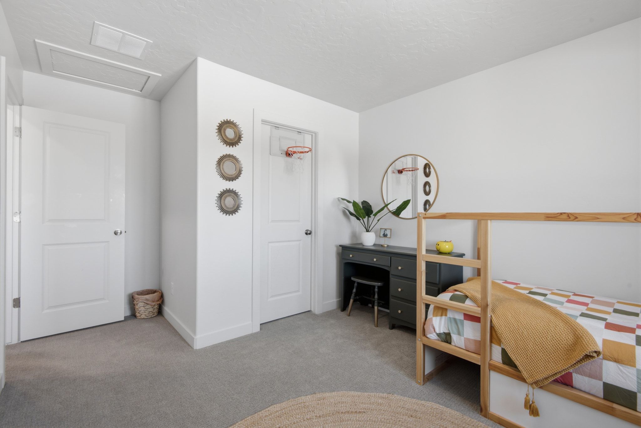 Well-lit interior room featuring light gray carpeting and white walls