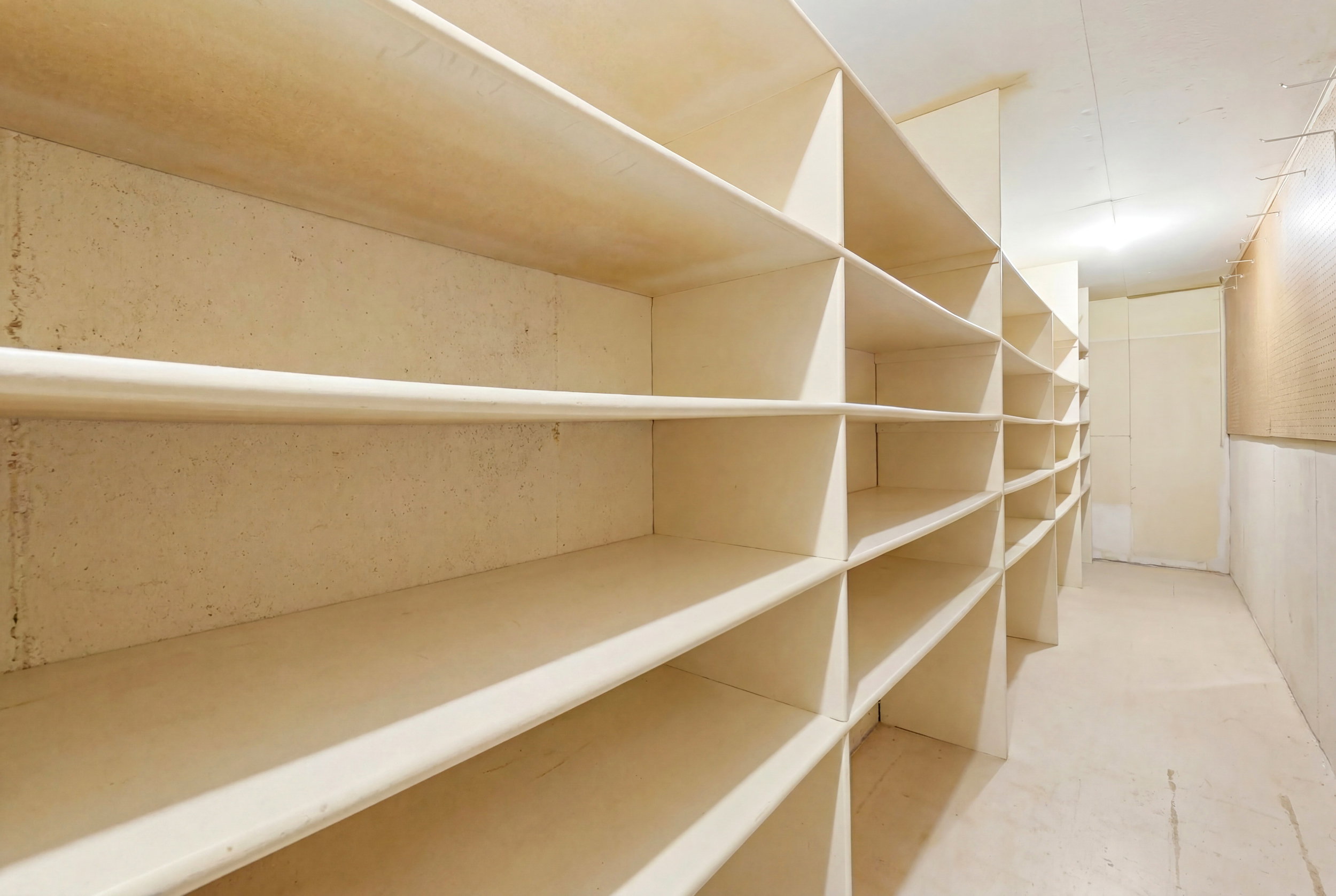 Dedicated storage area featuring extensive built-in shelving, providing abundant organizational capacity