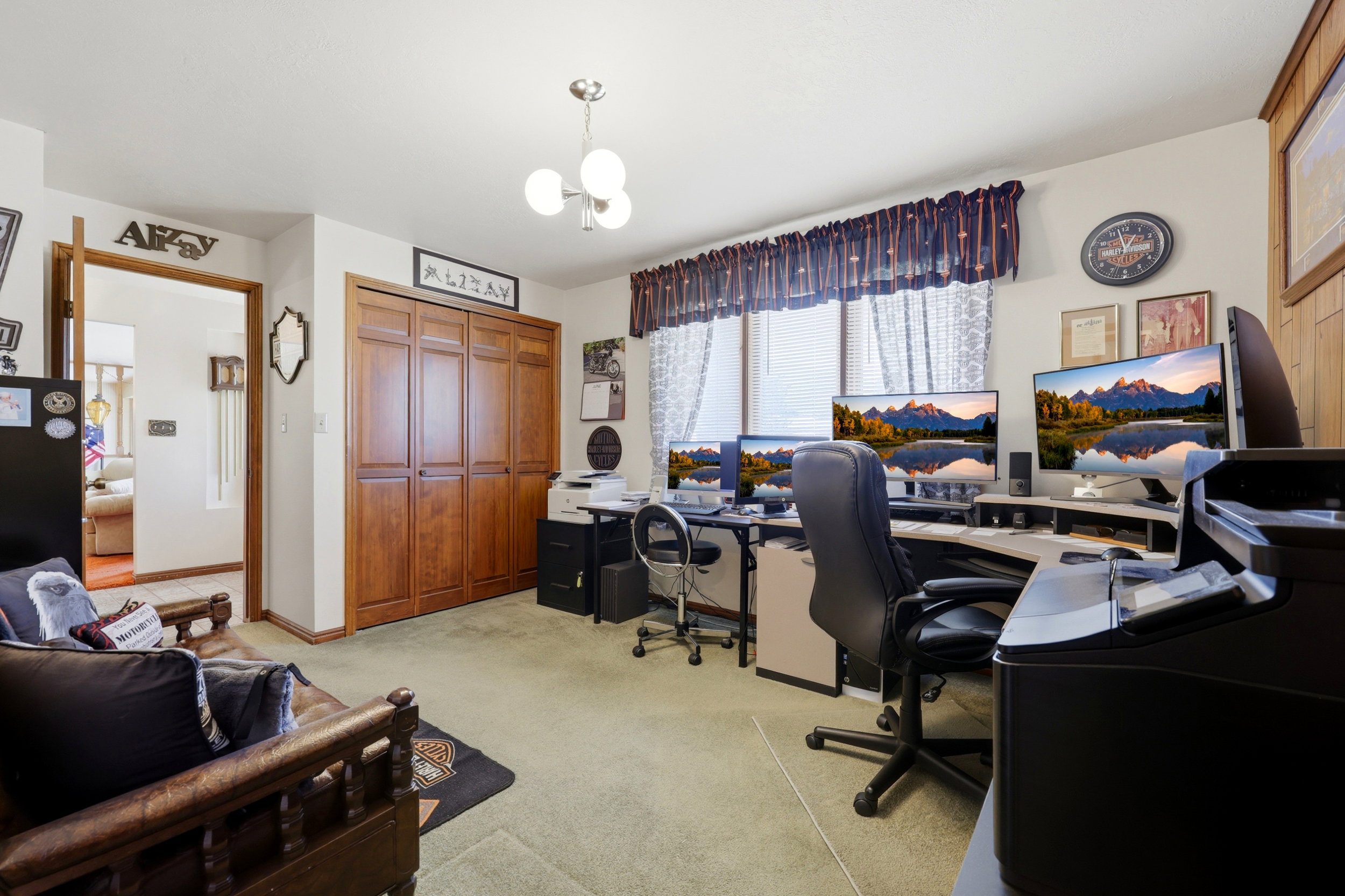 Spacious interior room featuring light green carpeting and a wall of wood-finish bi-fold closet doors