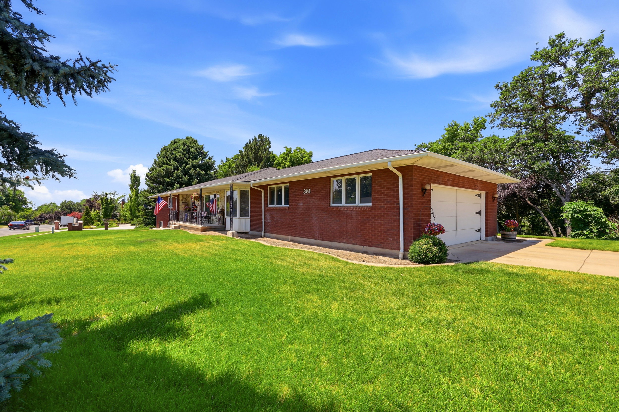 Brick exterior with a covered front porch and an attached two-car garage