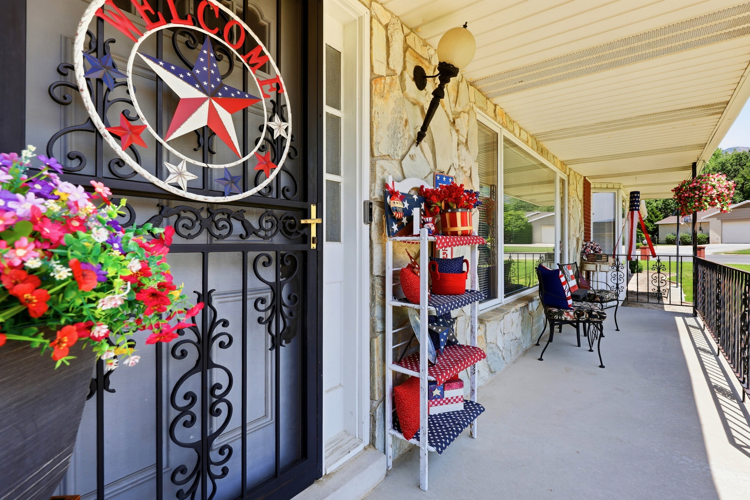 Covered front porch featuring a decorative security door with ornate ironwork