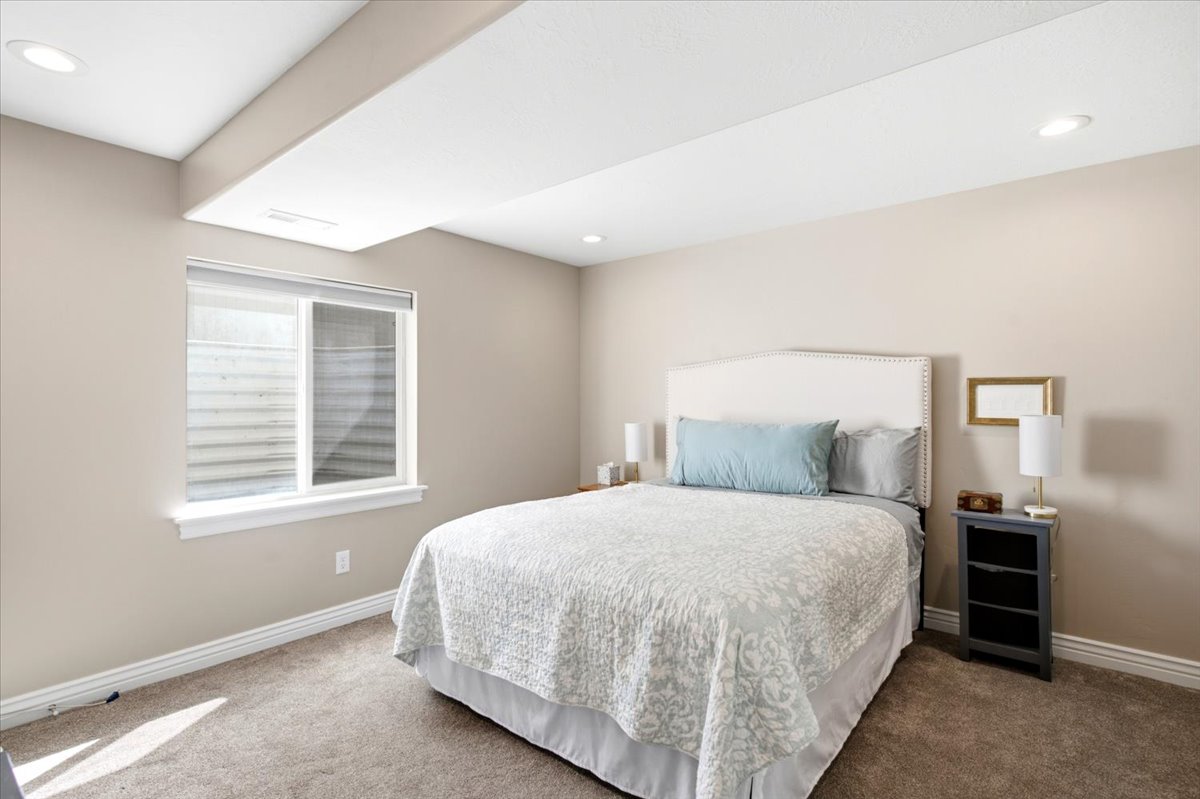 Carpeted room featuring a white window frame, recessed lighting, neutral wall tones, and white baseboards