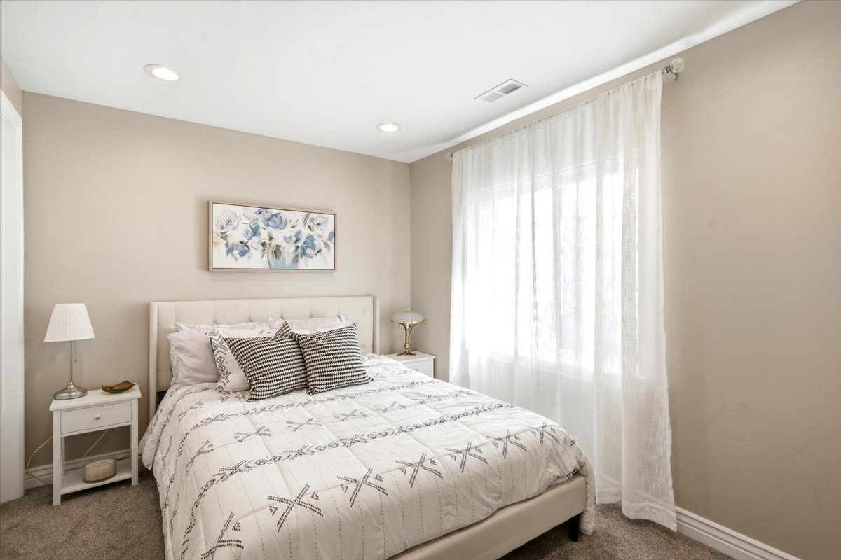 Bedroom featuring recessed lighting, a window with sheer curtains, neutral wall paint, and gray carpet flooring