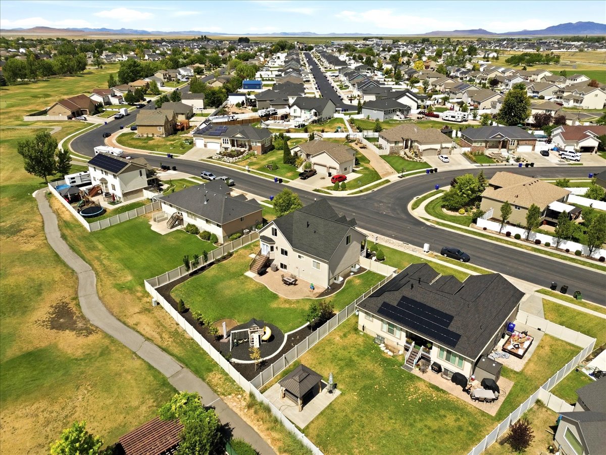 Expansive residential area featuring numerous single-family homes, paved streets, and green spaces