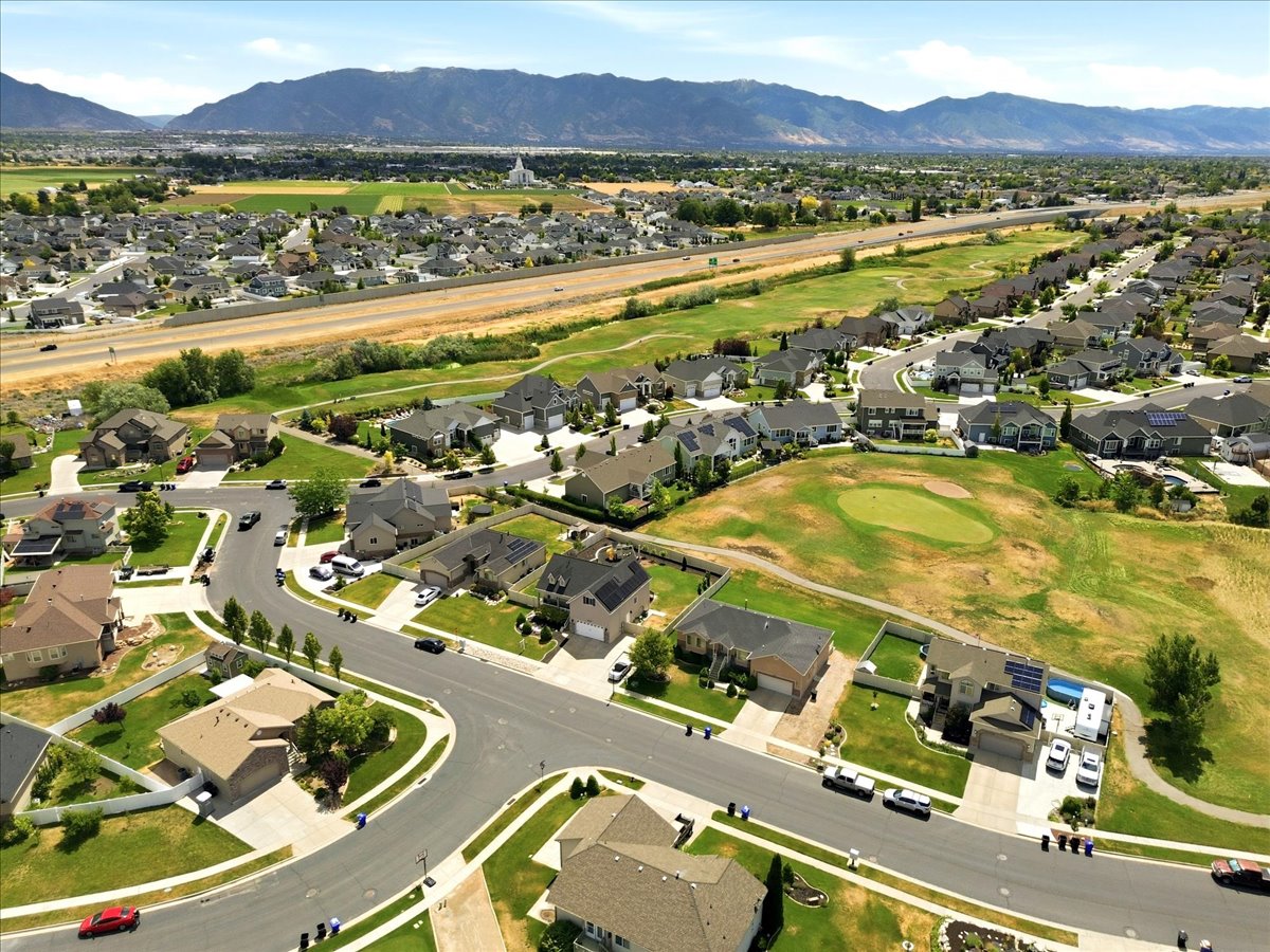 Aerial overview showcasing a residential neighborhood with mountain scenery