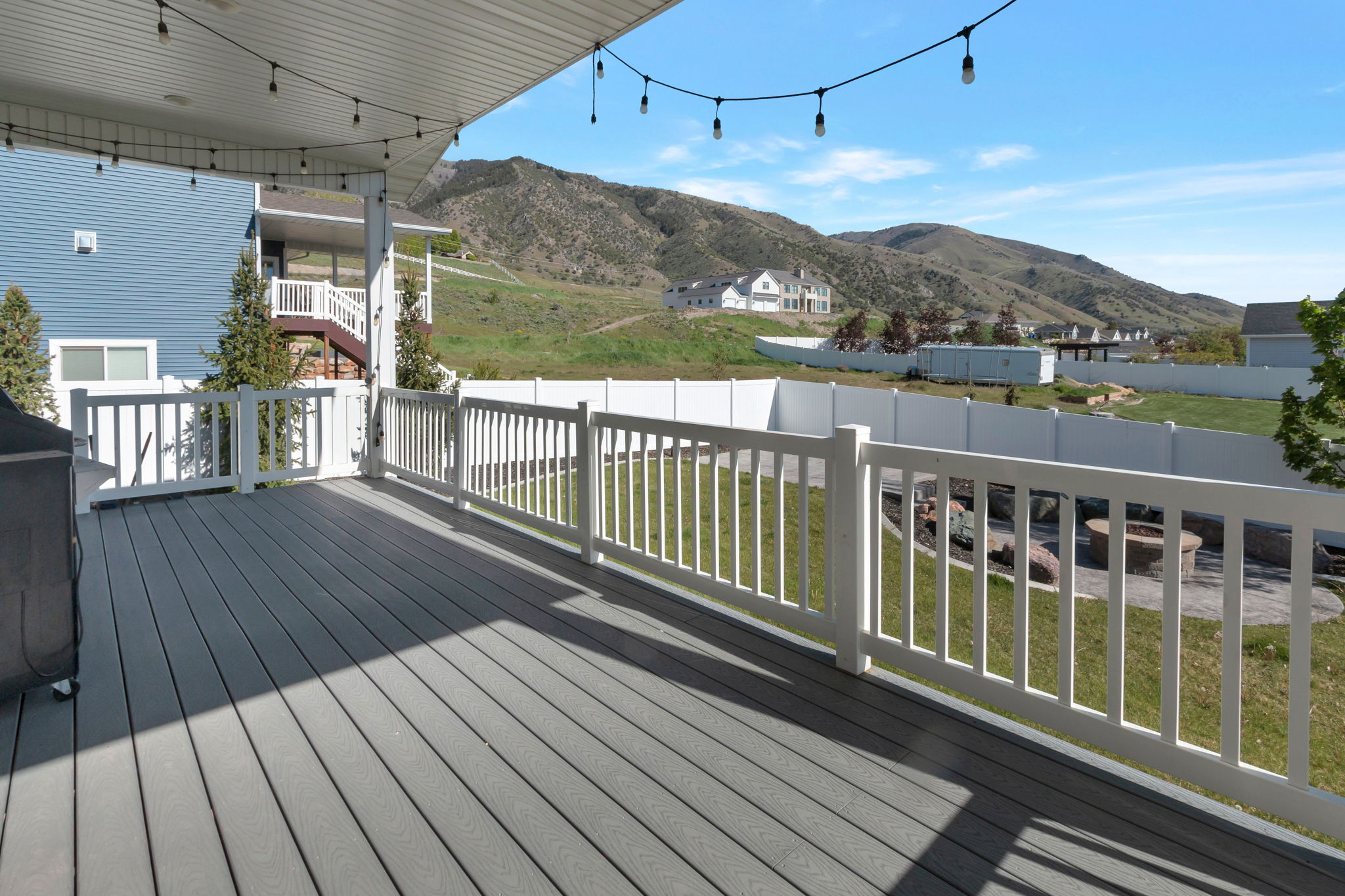 Spacious deck featuring composite decking and white railings