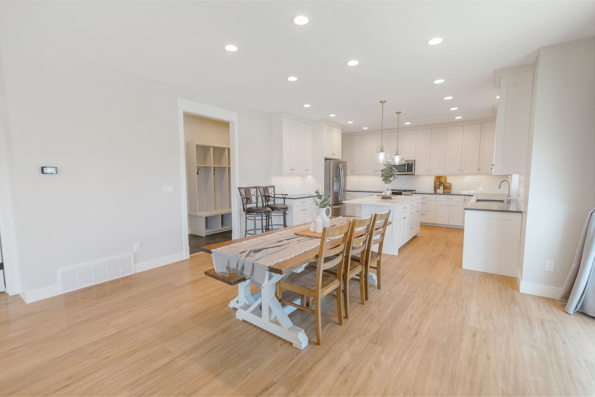 Open-concept living space featuring wood-finish flooring, recessed lighting, and white baseboards