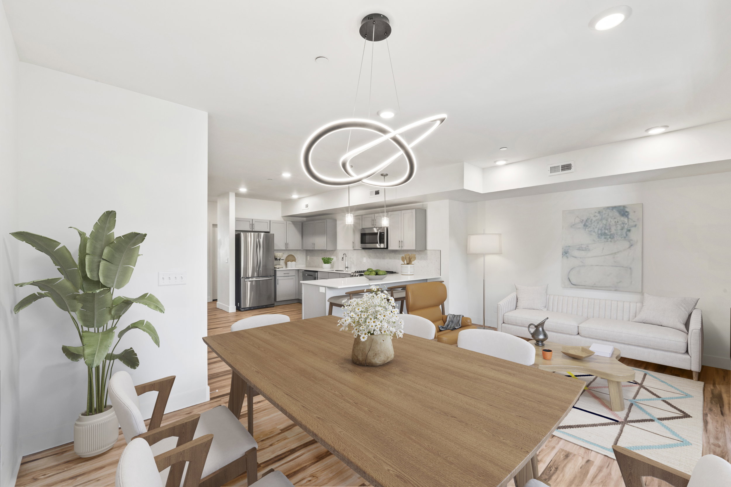 Open-concept living space featuring LVP flooring, recessed lighting, and a modern chandelier