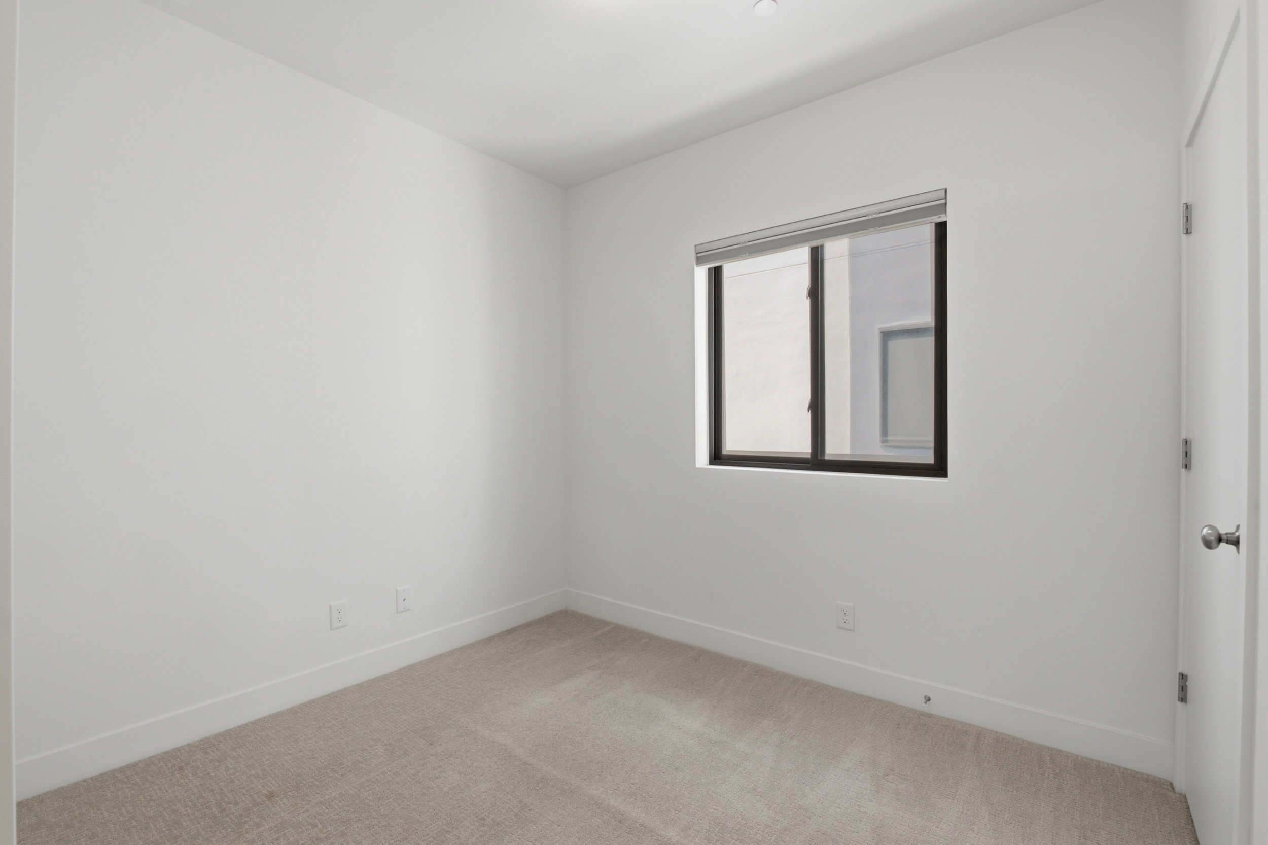 Bedroom on the main level featuring a sliding barn door - also makes a great office space!