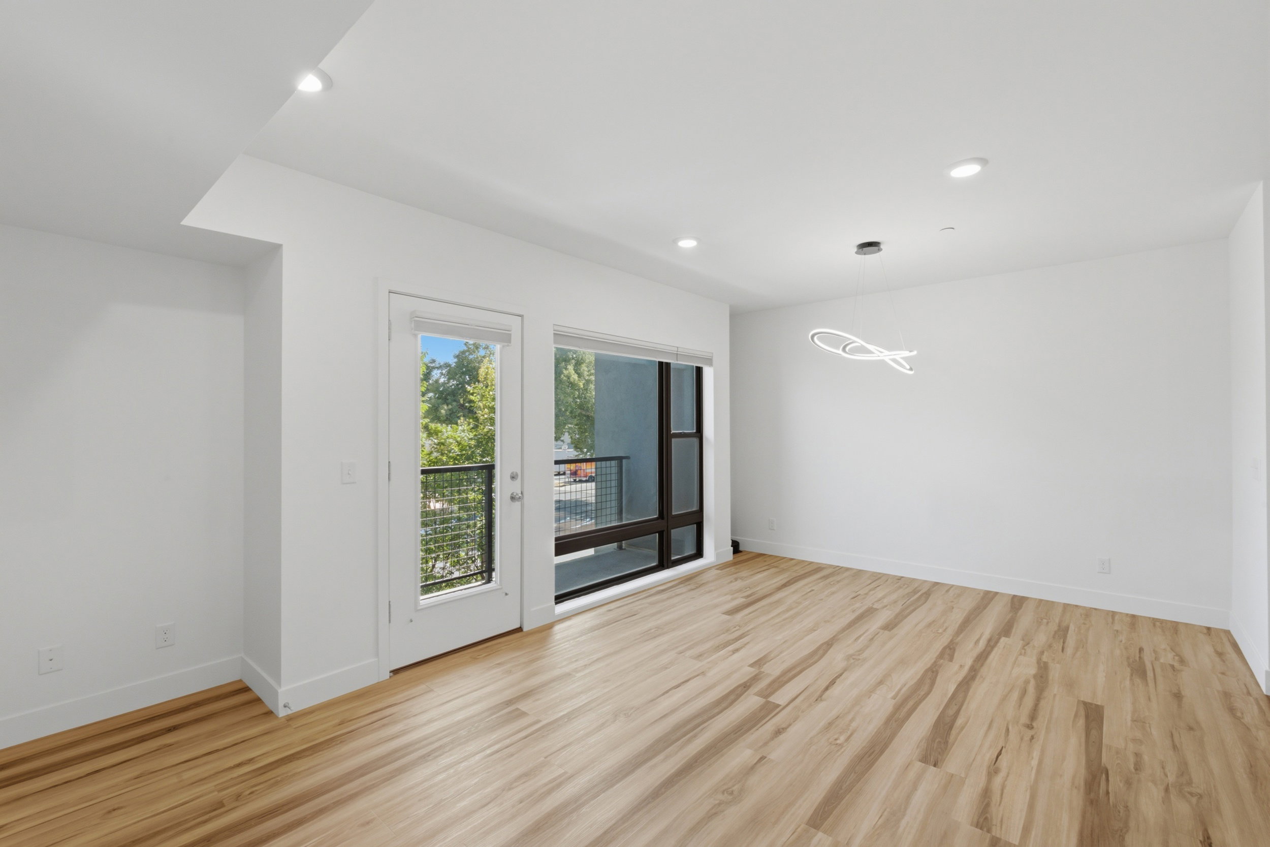 Spacious room with lots of natural light, and a contemporary dining chandalier