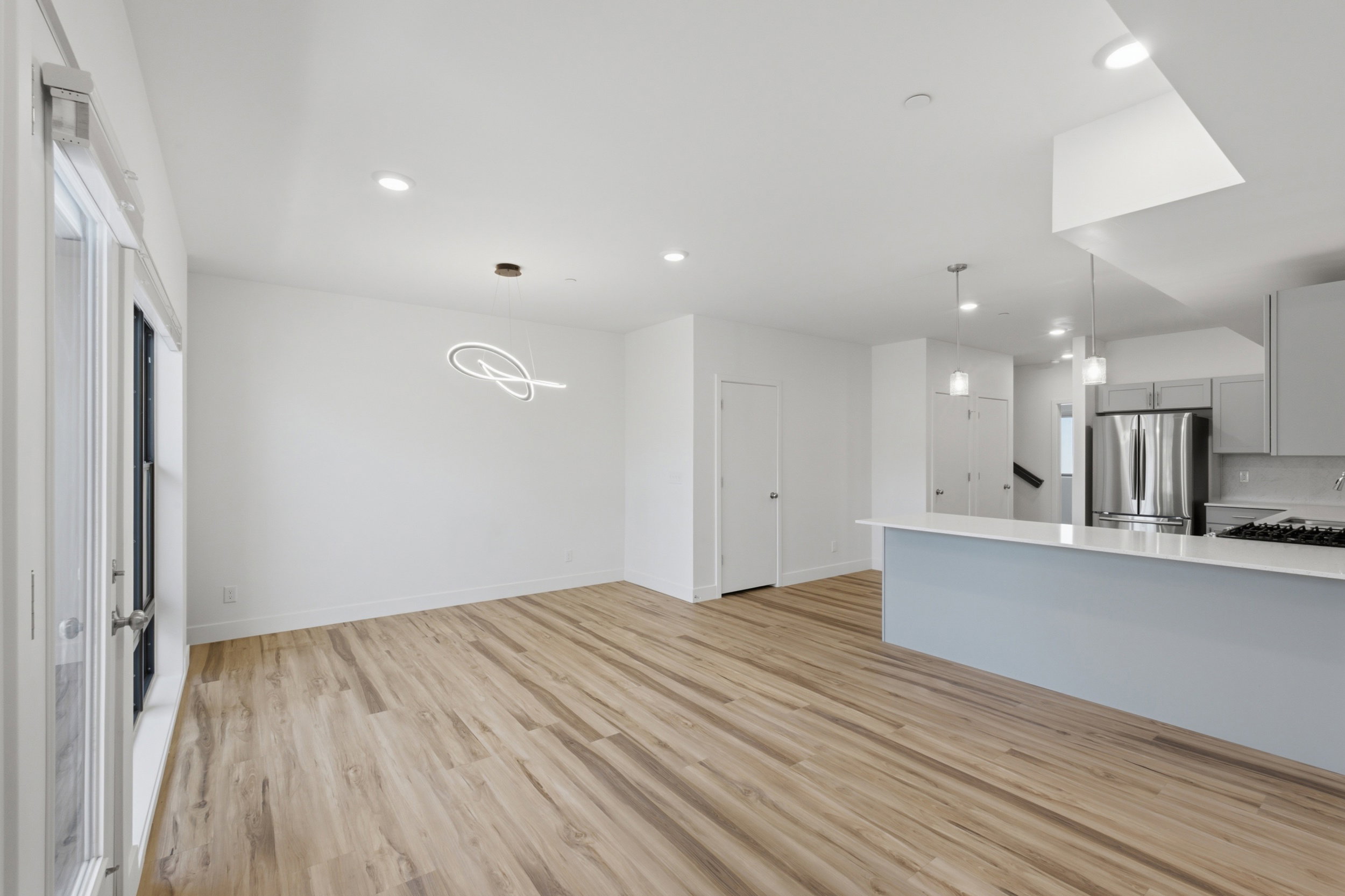 Open-concept living area with wood-finish flooring