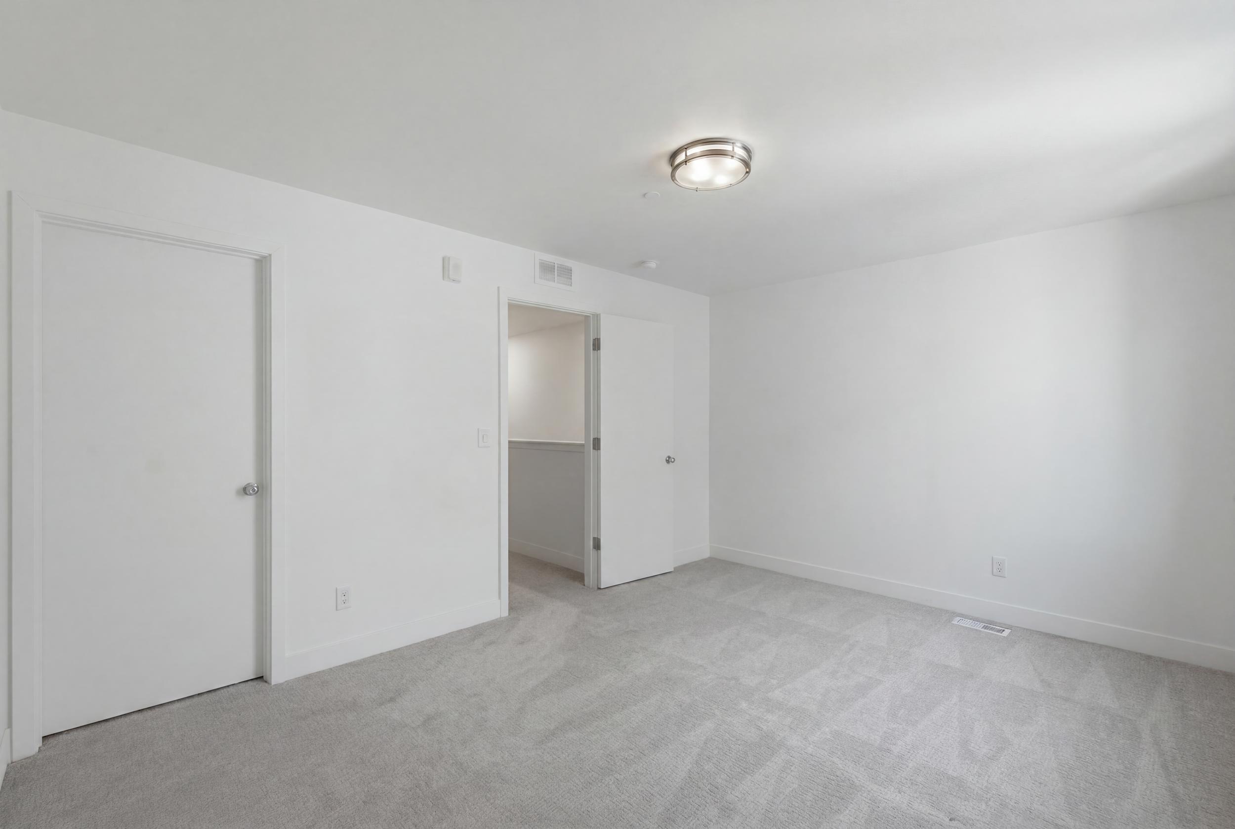 Second ensuite bedroom on upper level with walk-in closet