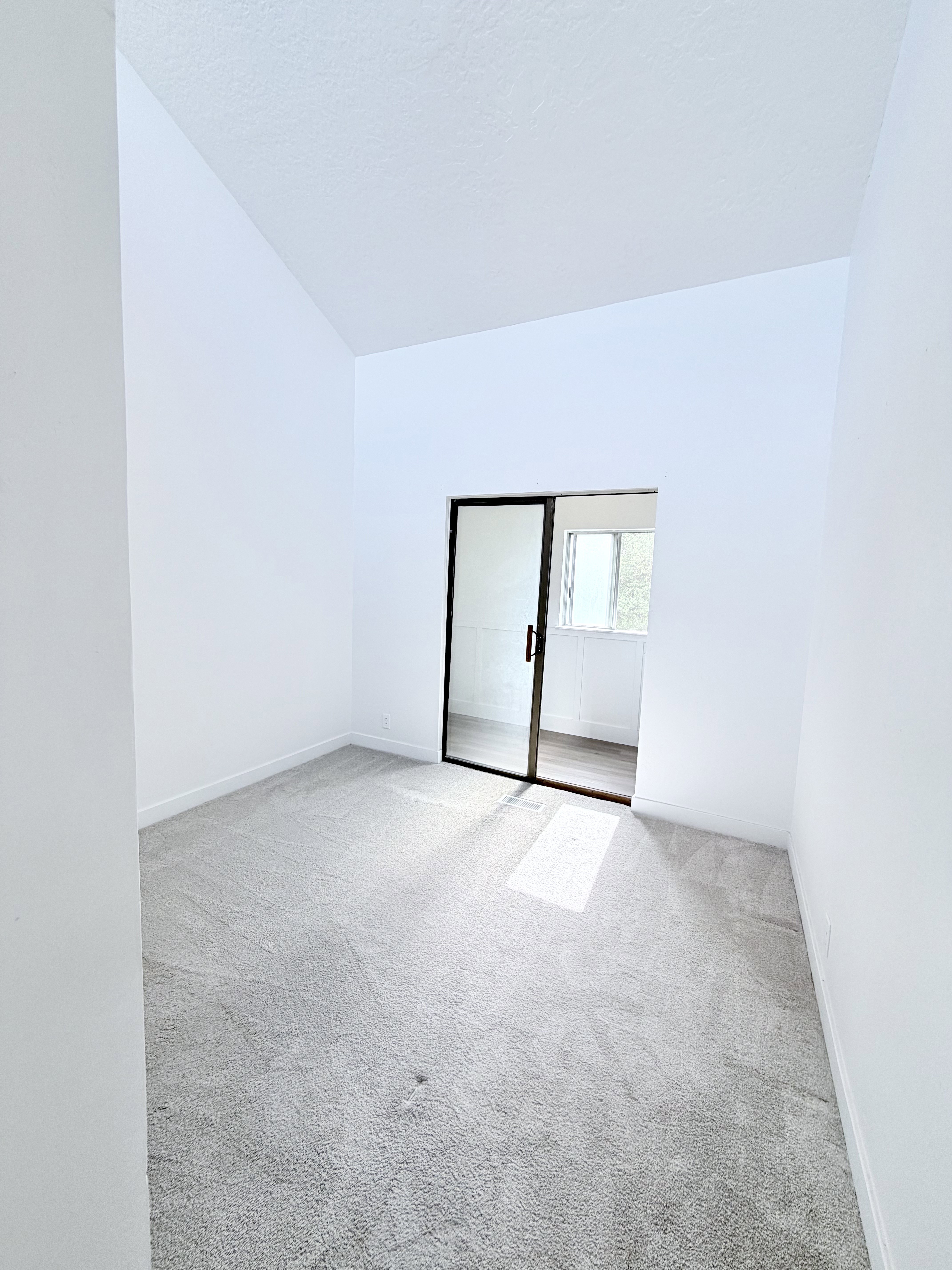 Room featuring light gray carpeting and white walls