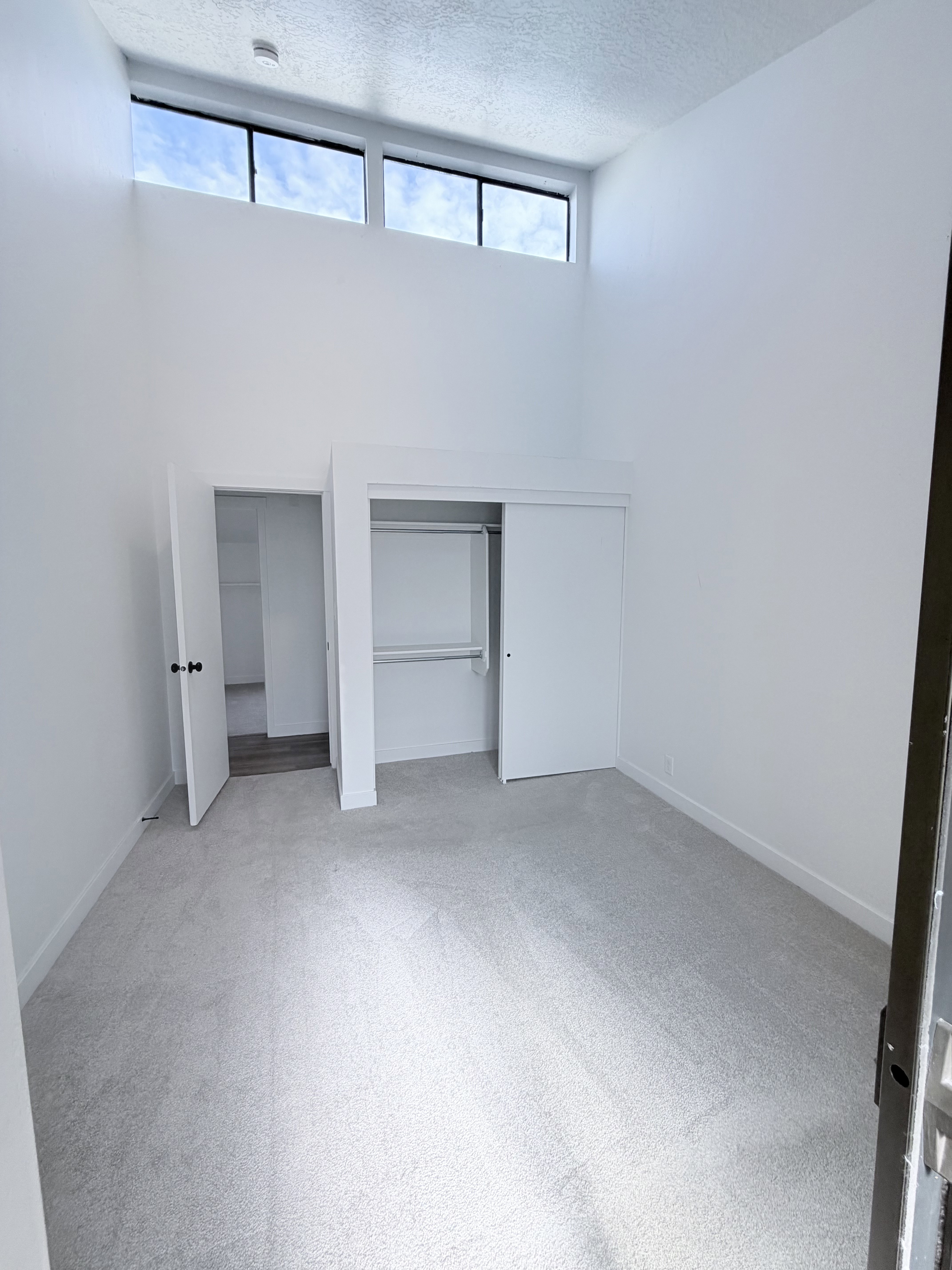 Interior room with vaulted ceilings and high-level windows