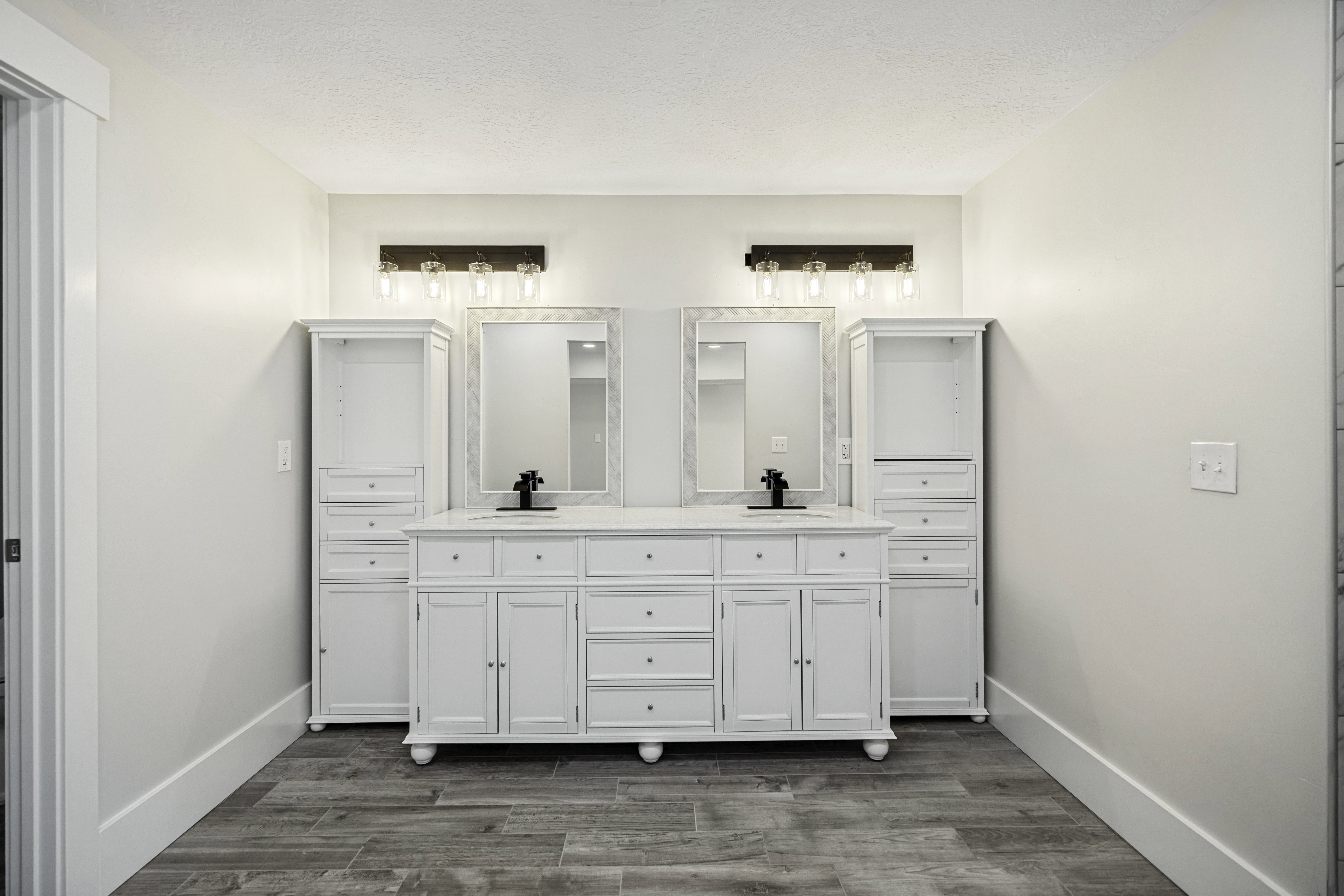 Spacious double vanity with white cabinetry, dual sinks, and matte black fixtures