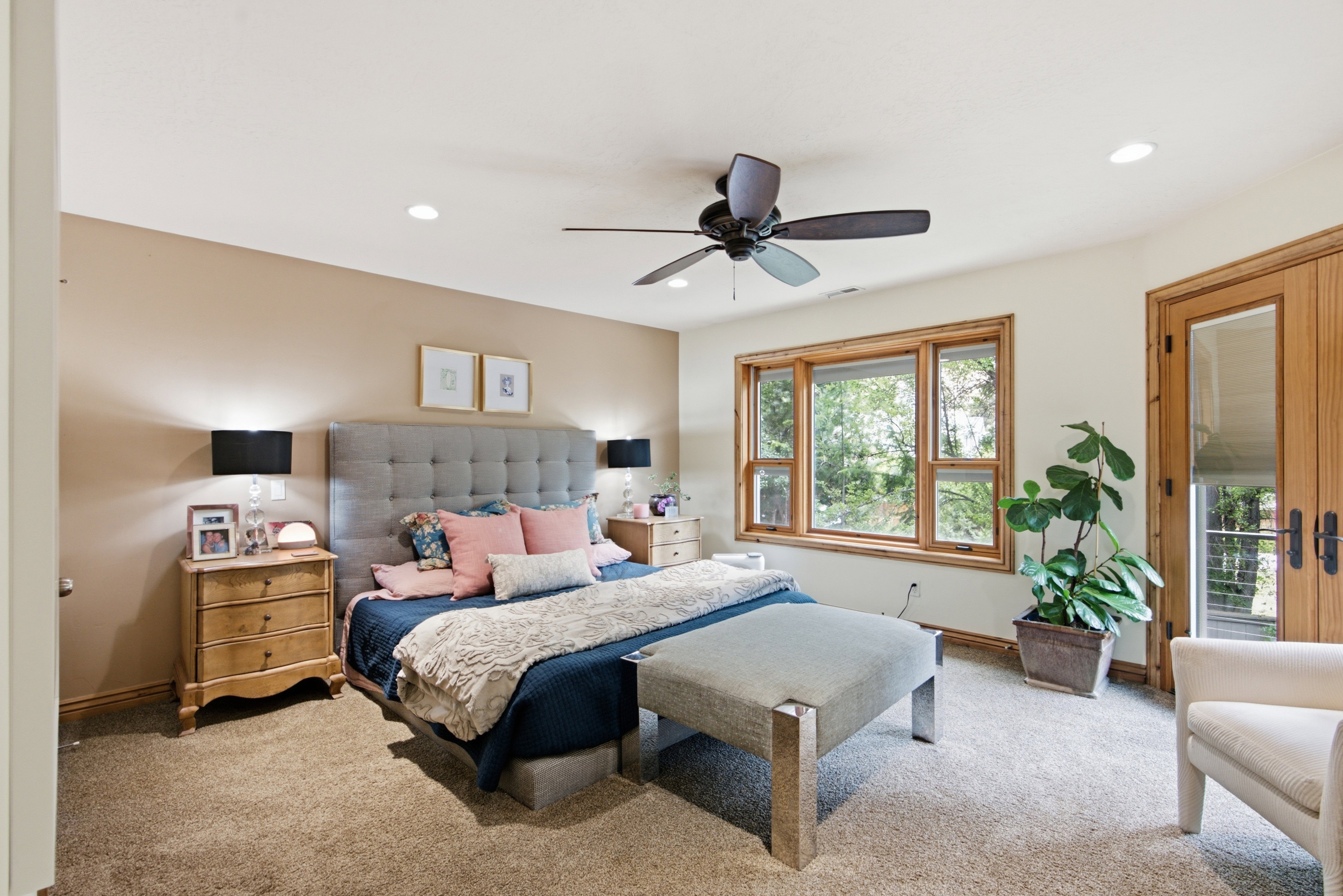 Spacious room featuring a multi-pane window, wood-finish French doors, a ceiling fan with light, recessed lighting, and soft carpet flooring